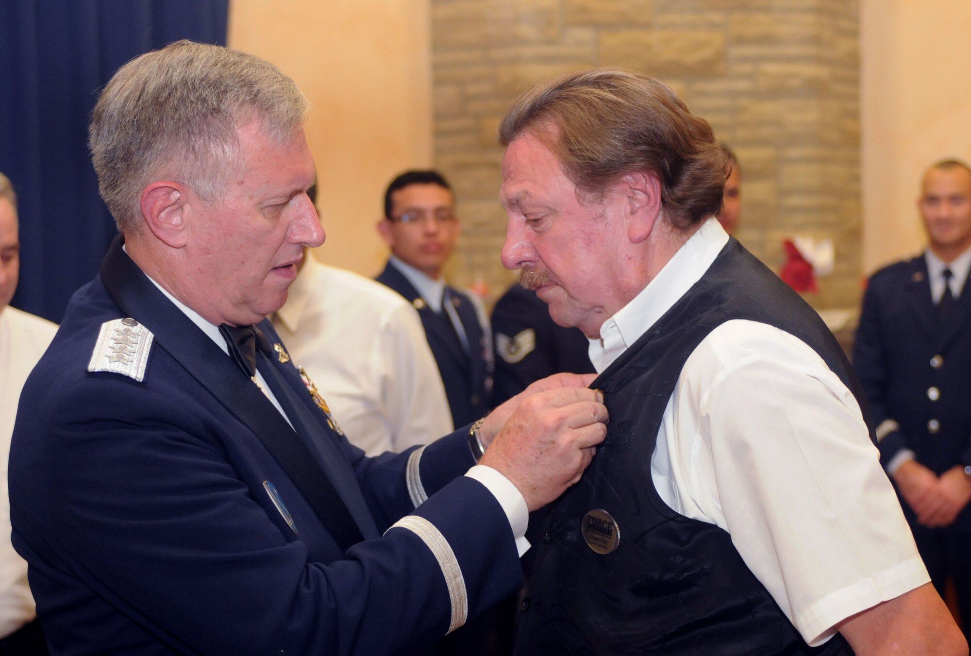 Gen. Roger A. Brady, U.S. Air Forces in Europe commander, celebrates Peter Plei’s retirement by attaching a 40-year retirement pin onto Mr. Plei’s lapel at the Air Force Ball held on Spangdahlem Air Base, Germany, Sept. 20, 2008. The 2008 Air Force Ball commemorates the Air Force’s 61st birthday. (U.S. Air Force photo by Master Sgt. Alexander Ray)