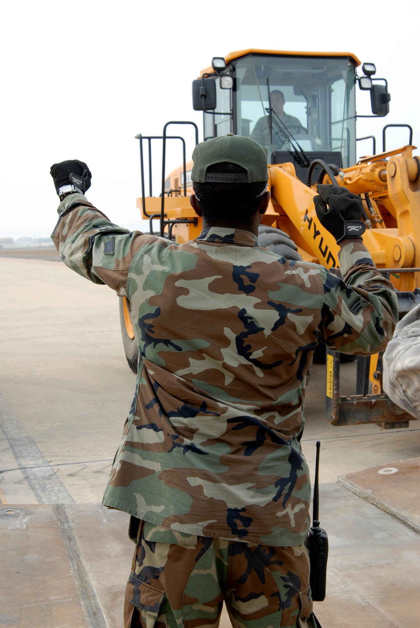 SrA Maurice Magee 8th Civil Engineer Squadron, directs the removal of two pieces of fiberglass cover during a joint USAF/Republic of Korean Air Forces airfield management training at Kunsan Air Base, Republic of Korea, October 21, 2008. (U.S. Air Force photo/Staff Sgt. Jason Colbert)