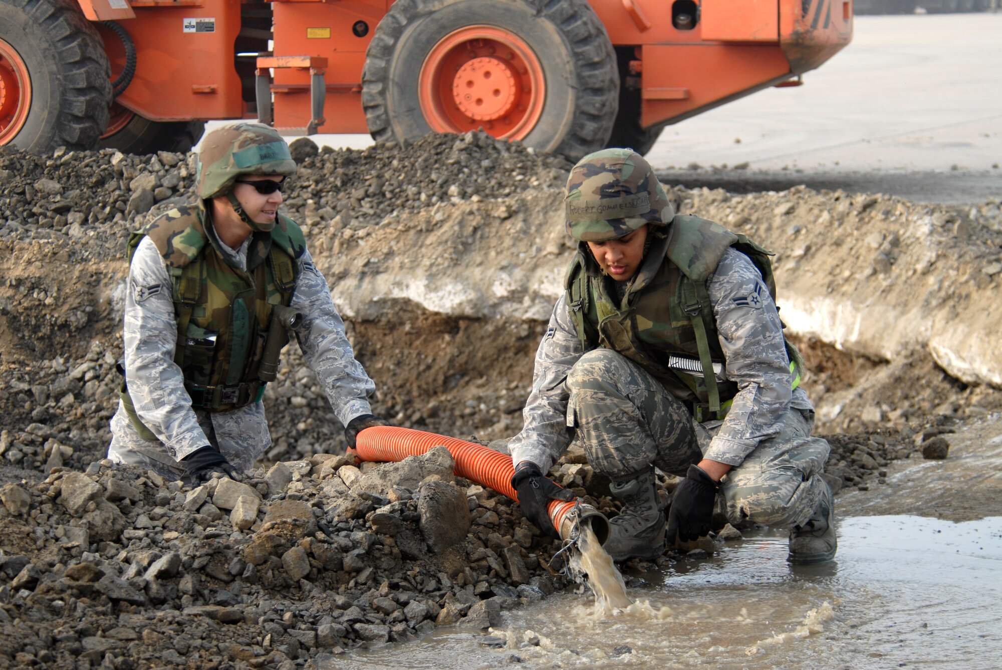 Senior Airman Adam Mellen and Airman 1st Class Robert Gommels, 8th Civil Engineer Squadron, pump water out of a crater during a joint USAF/Republic of Korean Air Forces airfield management training at Kunsan Air Base, Republic of Korea, October 21, 2008. (U.S. Air Force photo/Staff Sgt. Jason Colbert)