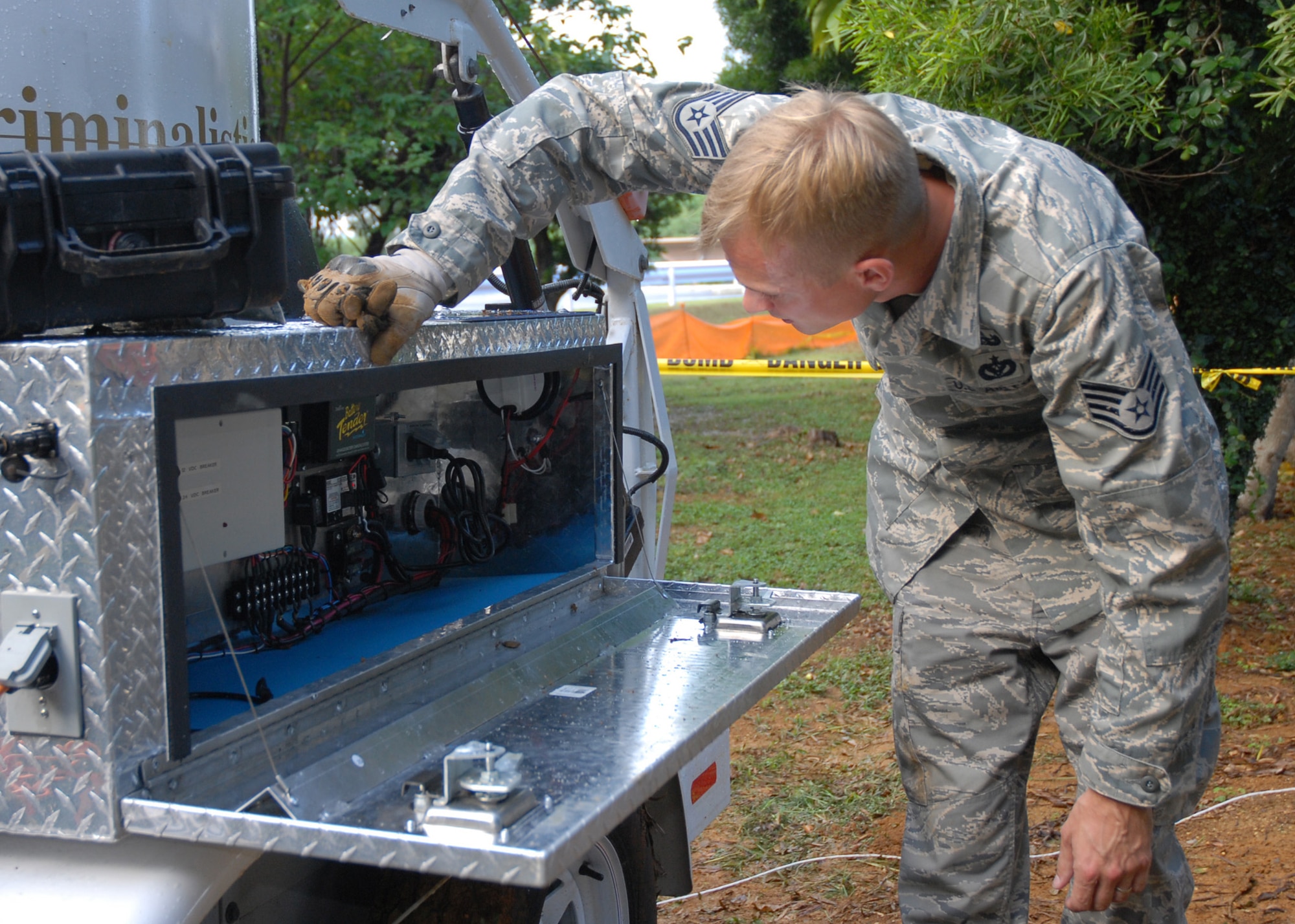 Staff Sgt. Jason Weimer, 18th Civil Engineer Squadron Explosive Ordnance Disposal specialist, prepares a specialized bomb containment vessel to remove a UXO at Kadena Air Base Oct. 19, 2008. The 18th Wing partnered with local government agencies to successfully remove the UXO while ensuring the safety of local citizens. EOD specialists safely destroyed the munition on the EOD range in the Kadena Munitions Storage Area. The 35-pound World War II-era rocket warheard was discovered near the base fence line during construction activities on Aug. 6. (U.S. Air Force photo/Airman 1st Class Amanda Grabiec)