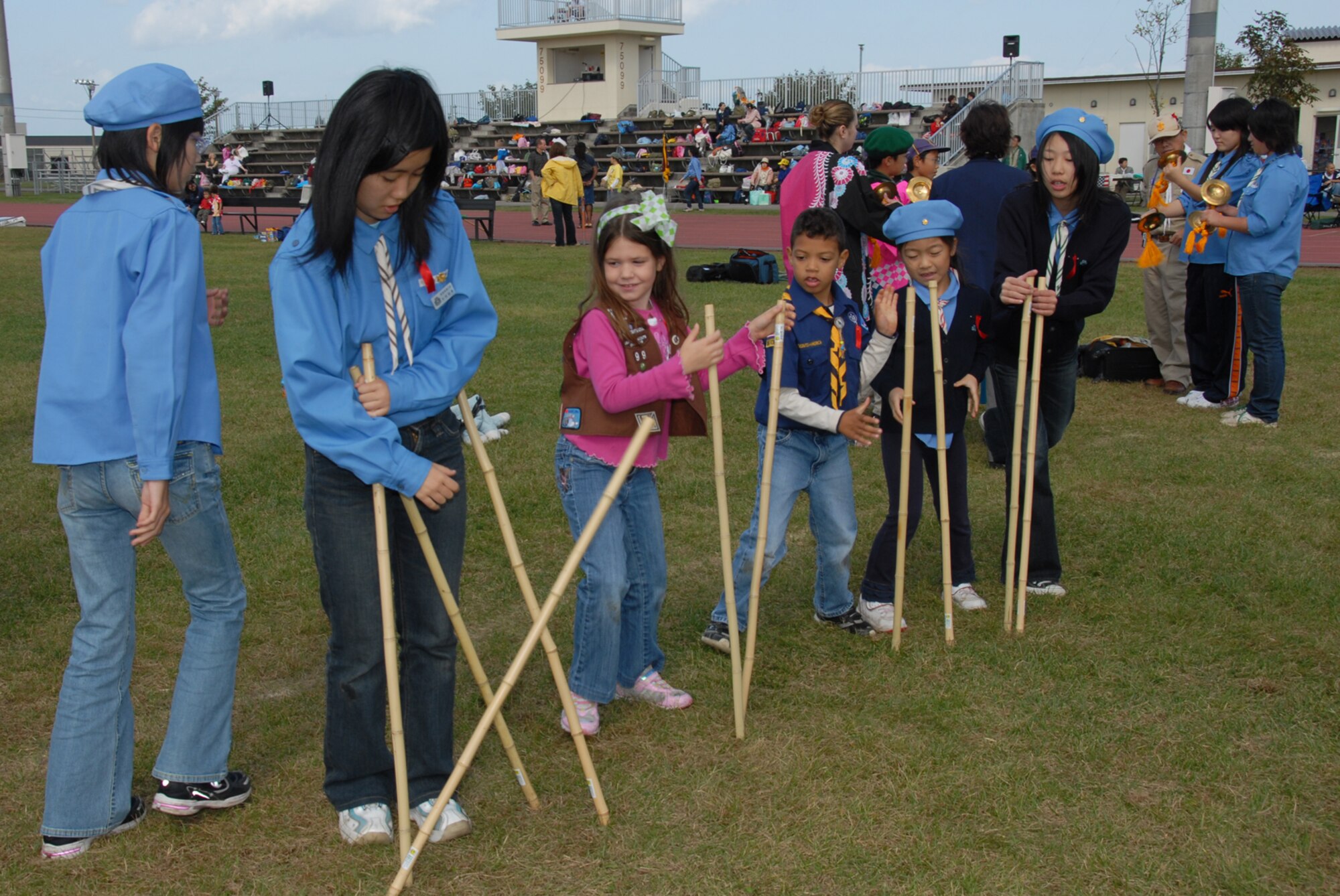 MISAWA AIR BASE, Japan -- Japanese and American Boys and Girls Scouts play a game of Takeasobi during International Scout Day Oct. 11, 2008. The object of the game is for the player to release the sticks and step to the right and grab the sticks that person was holding, without letting any sticks drop. (U.S. Air Force photo by Senior Airman Laura R. McFarlane)