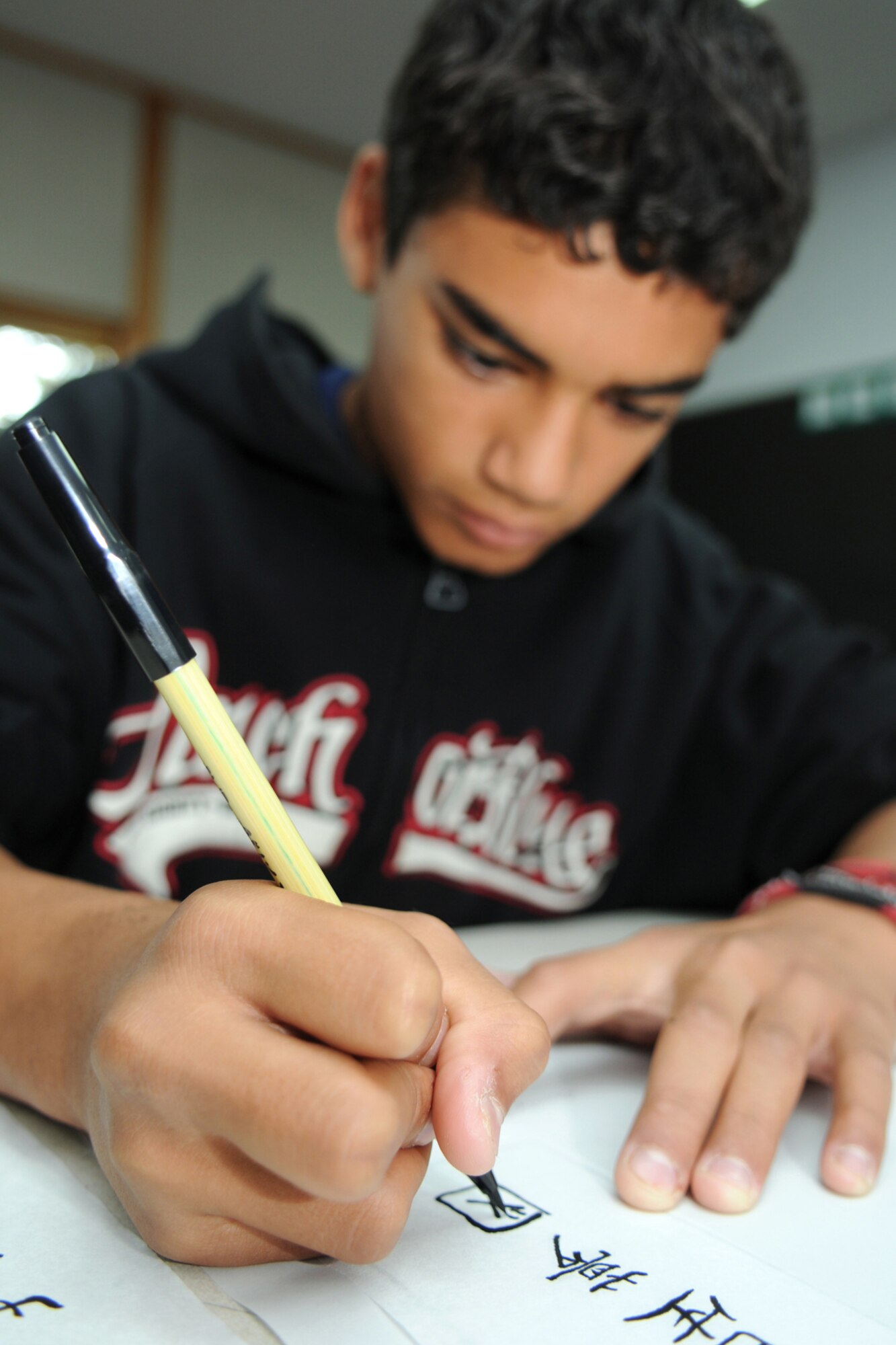 MISAWA AIR BASE, Japan -- James Bowman, son of Master Sgt. James Bowman, 35th Communications Squadron, practices calligraphy during educators day at Edgren High School Oct. 21, 2008. The word calligraphy translates to "shuji" in the Japanese language. (U.S. Air Force photo by Airman 1st Class Jamal D. Sutter) 