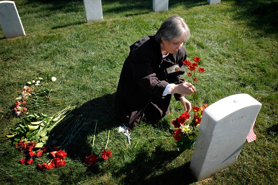 Deborah Peterson places flowers at the grave of her brother, Marine Cpl. James Chandonnet Knipple, Oct. 19, 2008, at Arlington National Cemetery. Peterson, her two sisters, and a handful of other family members gathered for the White House Commission on Remembrance’s 25th annual tribute to the 241 Americans, mostly Marines, killed in the Oct. 23, 1983, terrorist attacks on a Marine Corps barracks in Beirut, Lebanon. 
