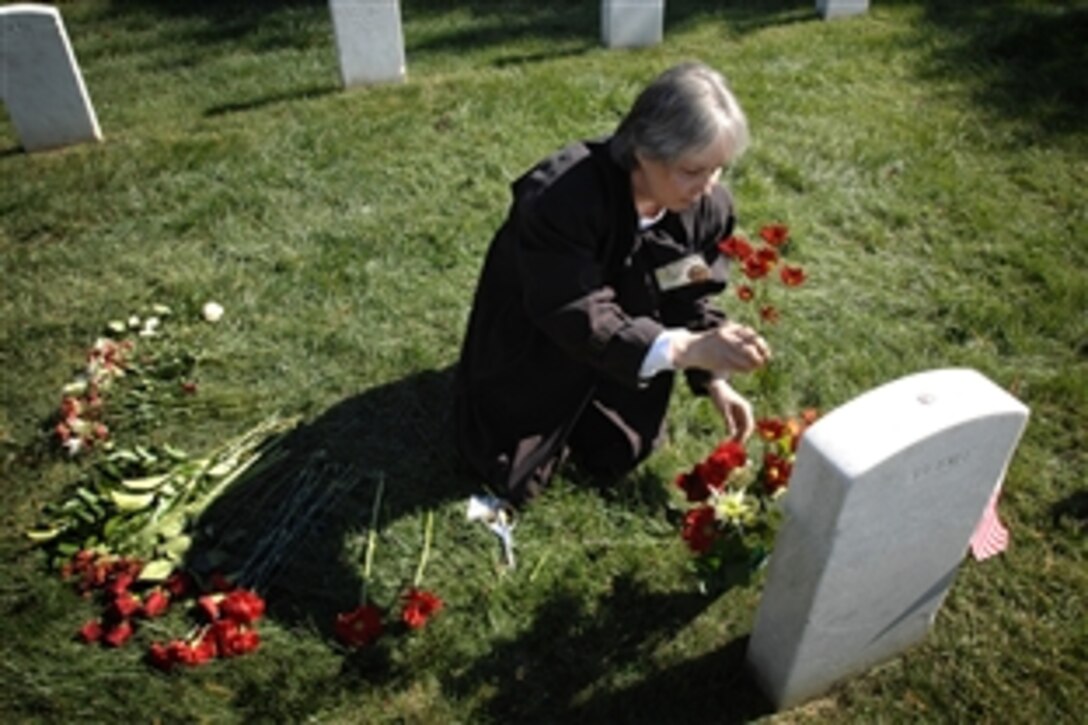 Deborah Peterson places flowers at the grave of her brother, Marine Cpl. James Chandonnet Knipple, Oct. 19, 2008, at Arlington National Cemetery. Peterson, her two sisters, and a handful of other family members gathered for the White House Commission on Remembrance’s 25th annual tribute to the 241 Americans, mostly Marines, killed in the Oct. 23, 1983, terrorist attacks on a Marine Corps barracks in Beirut, Lebanon.