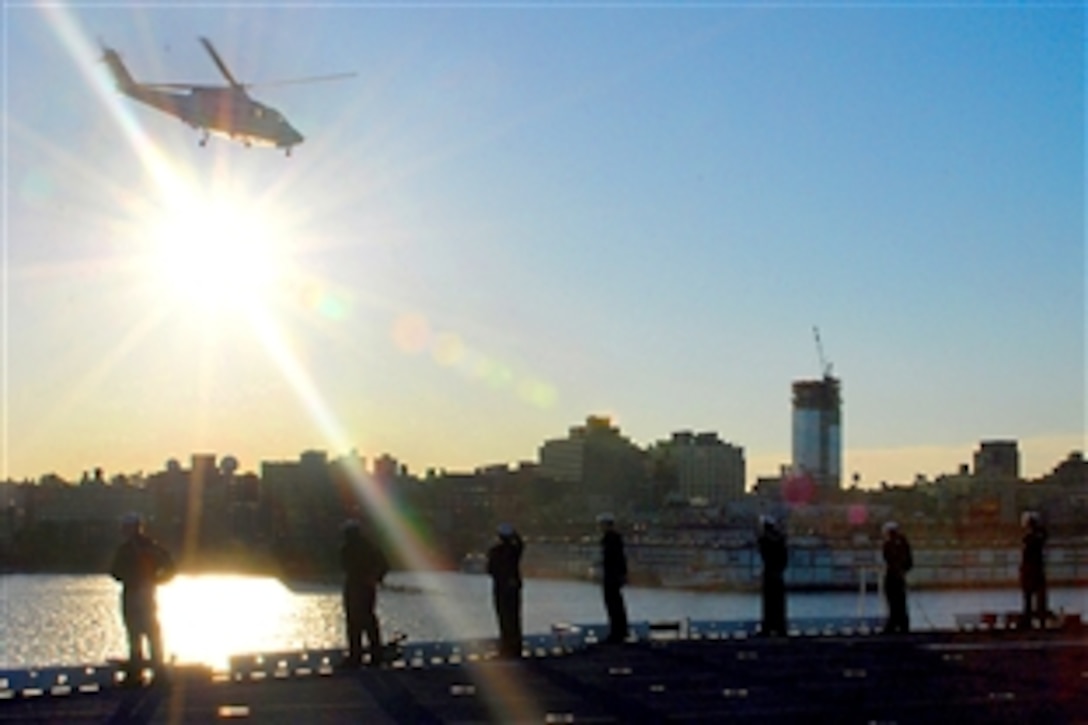 U.S. Navy sailors assigned to the amphibious assault ship USS Nassau man the rails for Nassau's arrival in New York City, Oct. 11, 2008. Nassau is in New York as part of the celebration for the 100th anniversary of the Great White Fleet.