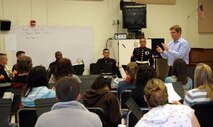Dave Larzelere, Waverly High School Band director, Lansing, Mich, introduces the Twentynine Palms Brass Quintet to his students Oct. 23. Members of the Brass Quintet from the Marine Corps Air Ground Combat Center Twentynine Palms, Calif., performed at Waverly High School, Lansing, Mich. Oct. 23. The Quintet went on a five-day tour of Recruiting Station Lansing Oct. 20-24, performing for the public and offering clinics for the students.