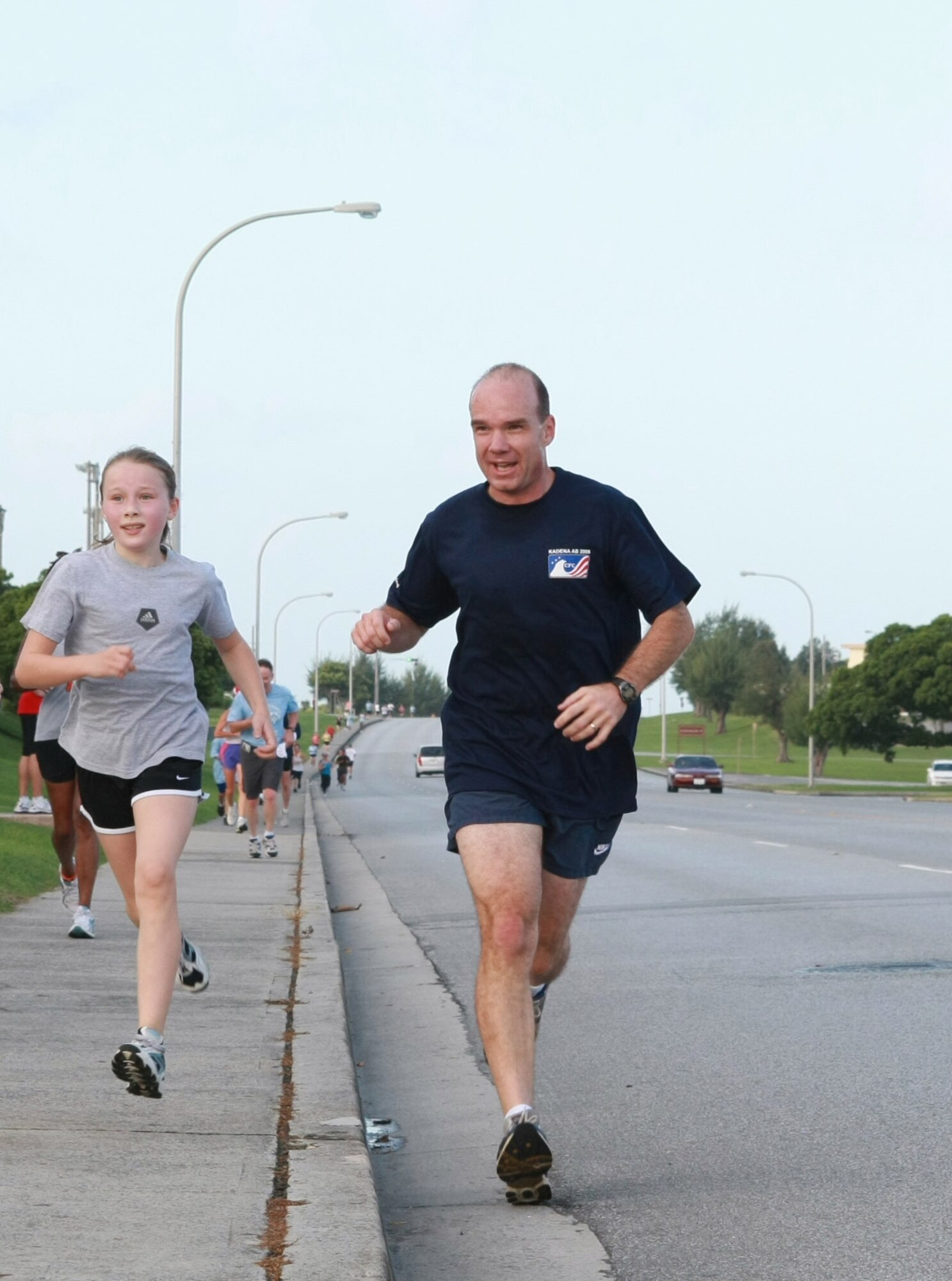 Col. Manson Morris (right), 18th Wing vice commander, makes his way to the finish line during the Special Olympics 5K Fun Run Oct. 18. More than 200 runners participated in the annual event which raised approximately $2,500 to support the Kadena Special Olympics which will be held Nov. 8. (Photo courtesy of Chip Steitz)