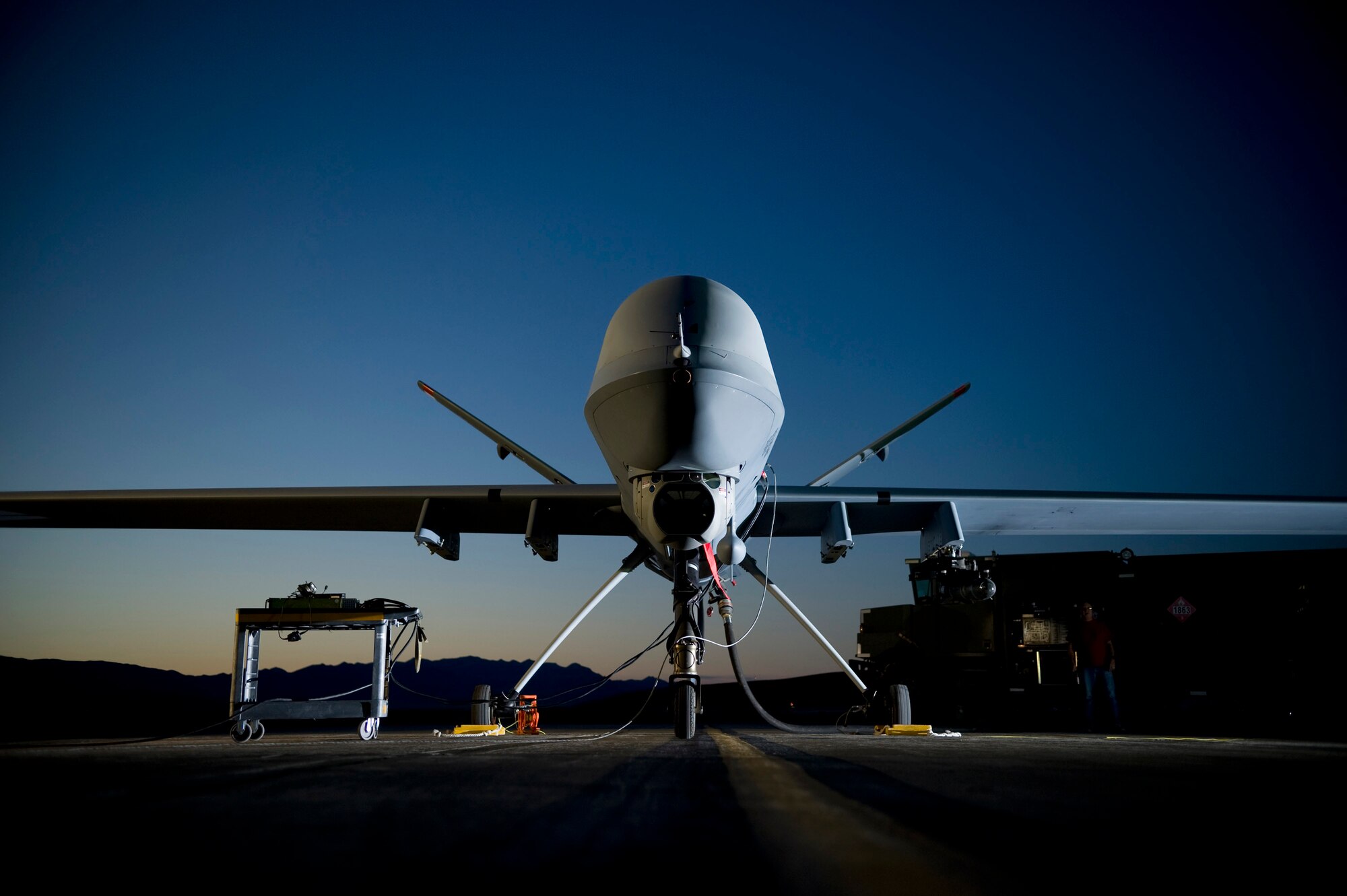 General Atomics Aeronautical Systems contractors refuel a MQ-9 Reaper at Creech Air Force Base, Nev., in June. Air Force officials announced a two-pronged approach to address the need for pilots of unmanned aerial vehicles such as the Reaper. (U.S. Air Force photo by Lance Cheung)