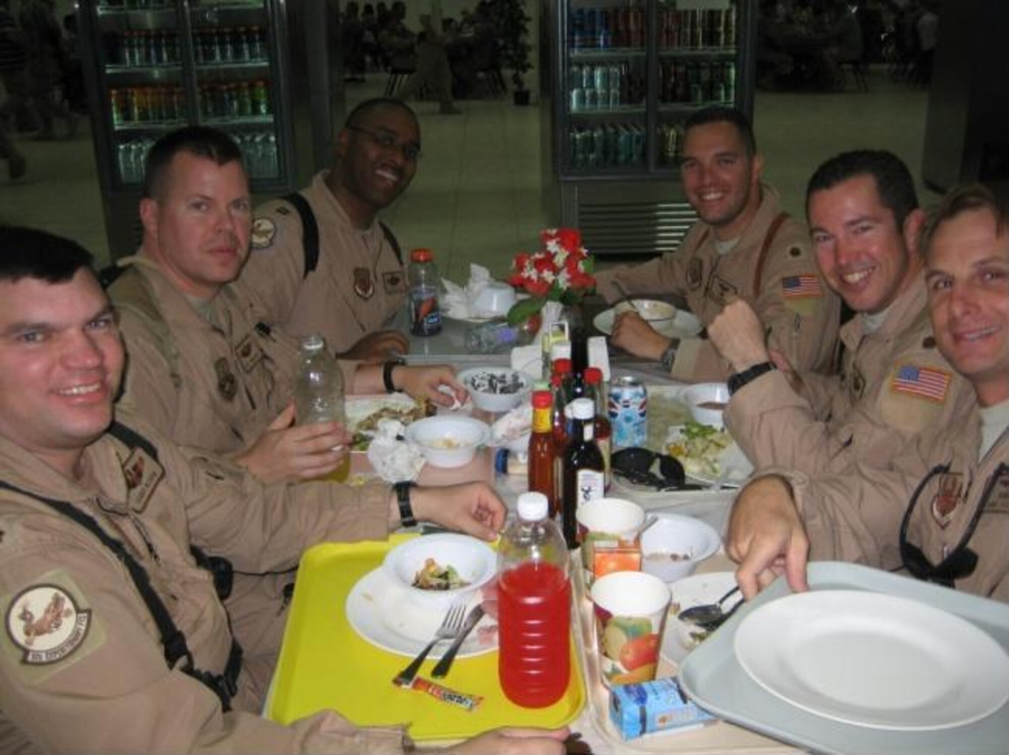 Team Vance members (left to right) Maj.Terry Bloom, Capt. Pat Thomason, Capt. Leon Butler and Maj. Joey Markusfeld eat dinner at the FOB Kirkuk Regional Air Base dining facility with Maj. Scott McCartt and Capt. Jamie Riddle of Columbus Air Force Base. (U.S. Air Force photo by Maj. Joseph Markusfeld)