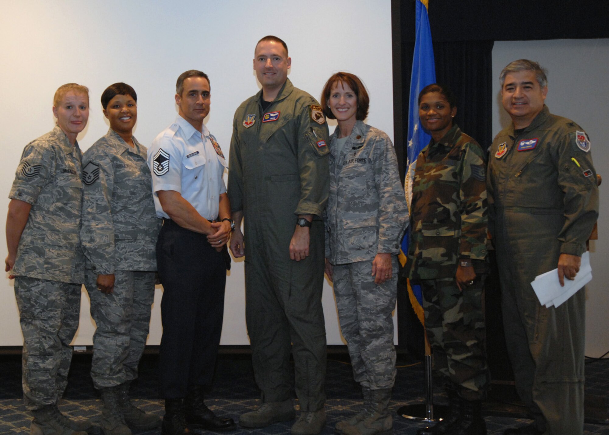 Distinguished visitors, Senior Master Sgt. Raymon Colon-Lopez, commandant for the Air Force Pararescue in Combat Rescue Officer School and Captain Bryan Dresser, Air Combat Command A-10 pilot, pose for a group photo in the Desert Sands Enlisted Club, at Holloman Air Force Base, N.M., October 17. During Warrior Call, both DV's used slide show presentations to share their military experiences. (U.S. Air Force photo/Airman 1st Class Veronica Salgado)