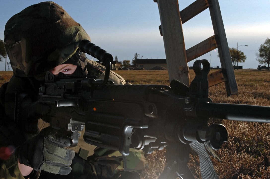 Senior Airman Christopher Roberts, 28th Security Forces Squadron police officer, provides perimeter security with an M-240 machine gun during an exercise here, Oct. 22. The exercises are held before deployments to prepare security forces members for threats they may encounter. (U.S. Air Force photo/Airman Corey Hook)