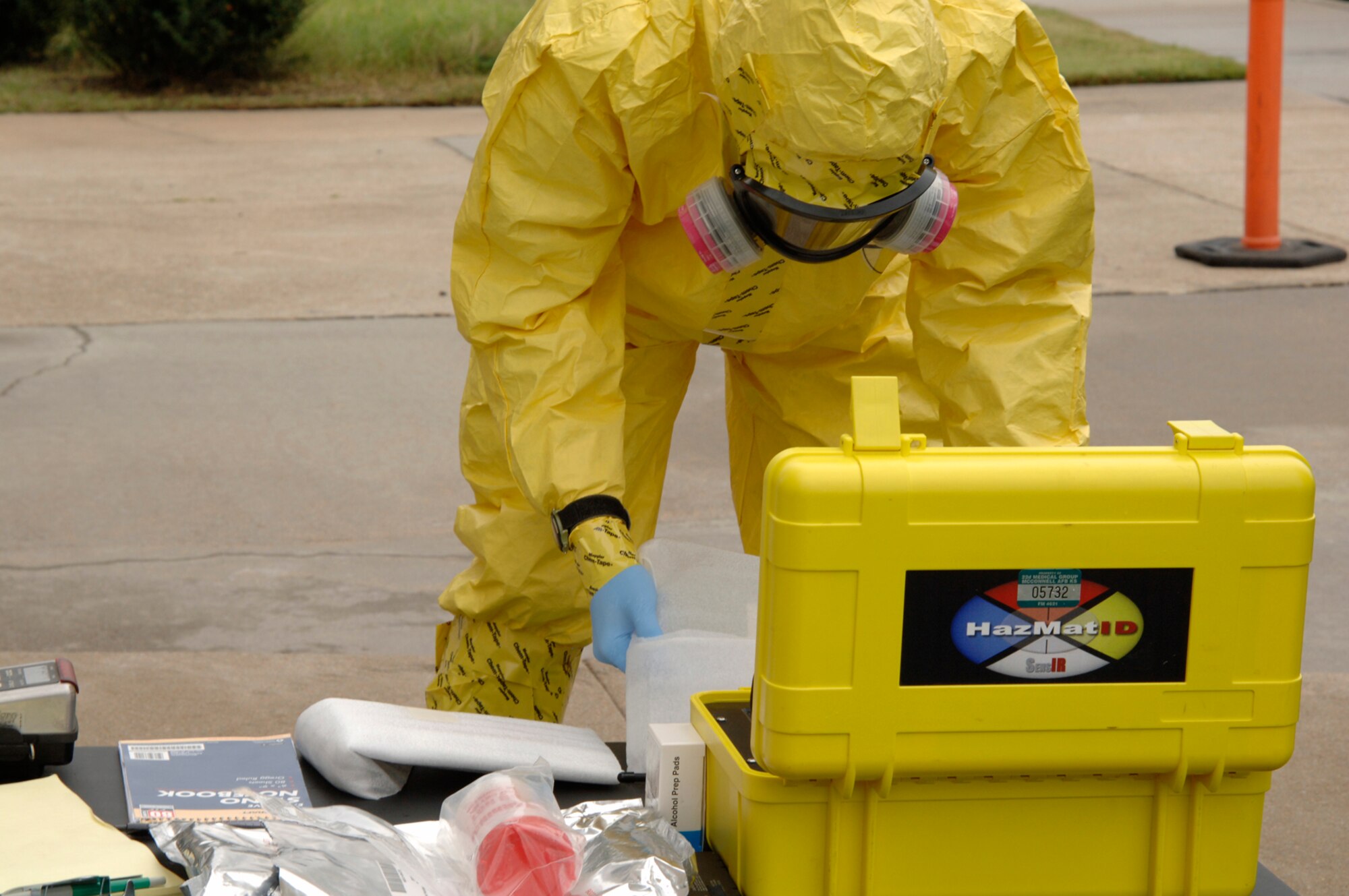 MCCONNELL AIR FORCE BASE, Kan. -- Senior Airman Matthew Rosenfeldt, 22nd Aerospace Medicine Squadron, examines powder from a suspicious package outside building 750, during a major accident response exercise, Oct 15. Airmen in the bioenvironmental lab are responsible for testing any solid and liquid chemical agents that could be harmful to personnel in the local area. (Photo by Senior Airman Laura Suttles)