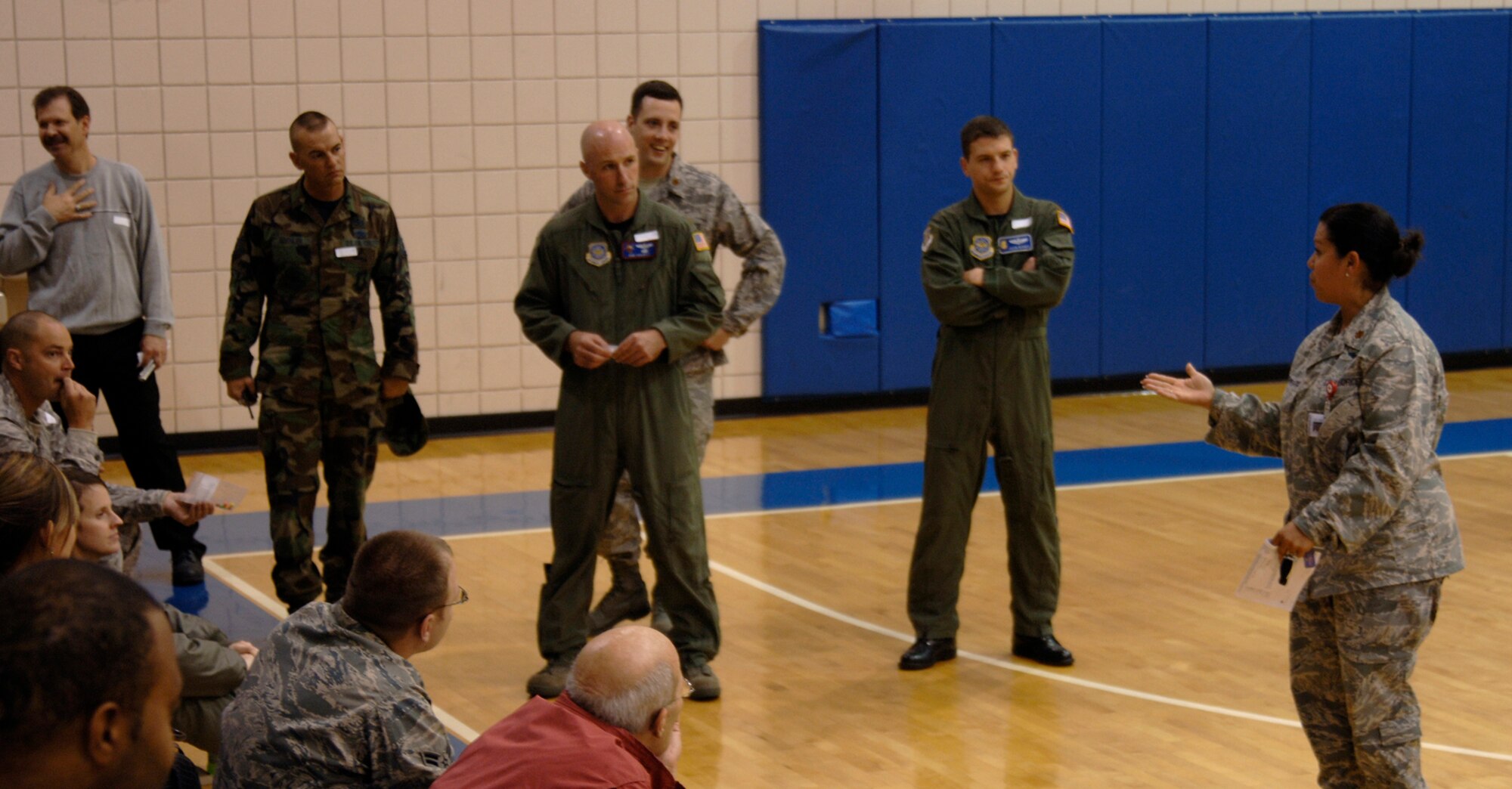 MCCONNELL AIR FORCE BASE, Kan. -- Major Xiomara Santana-Jones, 22nd Aerospace Medicine Squadron, briefs building 750 personnel in the base fitness center about symptoms and antidotes for Anthrax during a major accident response exercise, Oct 15. The McConnell members’ role during the exercise was simulating symptoms of the Anthrax virus and to go through a decontamination line. Personnel were instructed by Major Santana-Jones to take a prescribed simulated medicine and report to the doctor if further symptoms presented. (Photo by Senior Airman Laura Suttles)