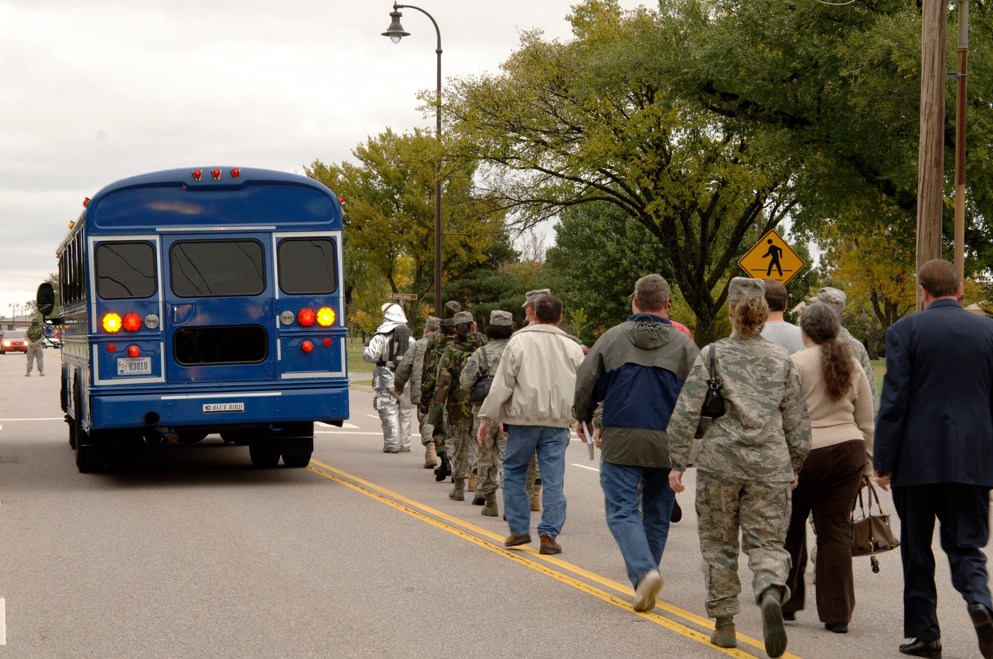 MCCONNELL AIR FORCE BASE, Kan. -- During a major accident response exercise, Team McConnell members role-play as Anthrax contaminated individuals who board a bus headed towards the Robert J. Dole Fitness Center for treatment, Oct. 15. The contaminated members waited in building 750 before walking through a decontamination process. (Photo by Senior Airman Laura Suttles)