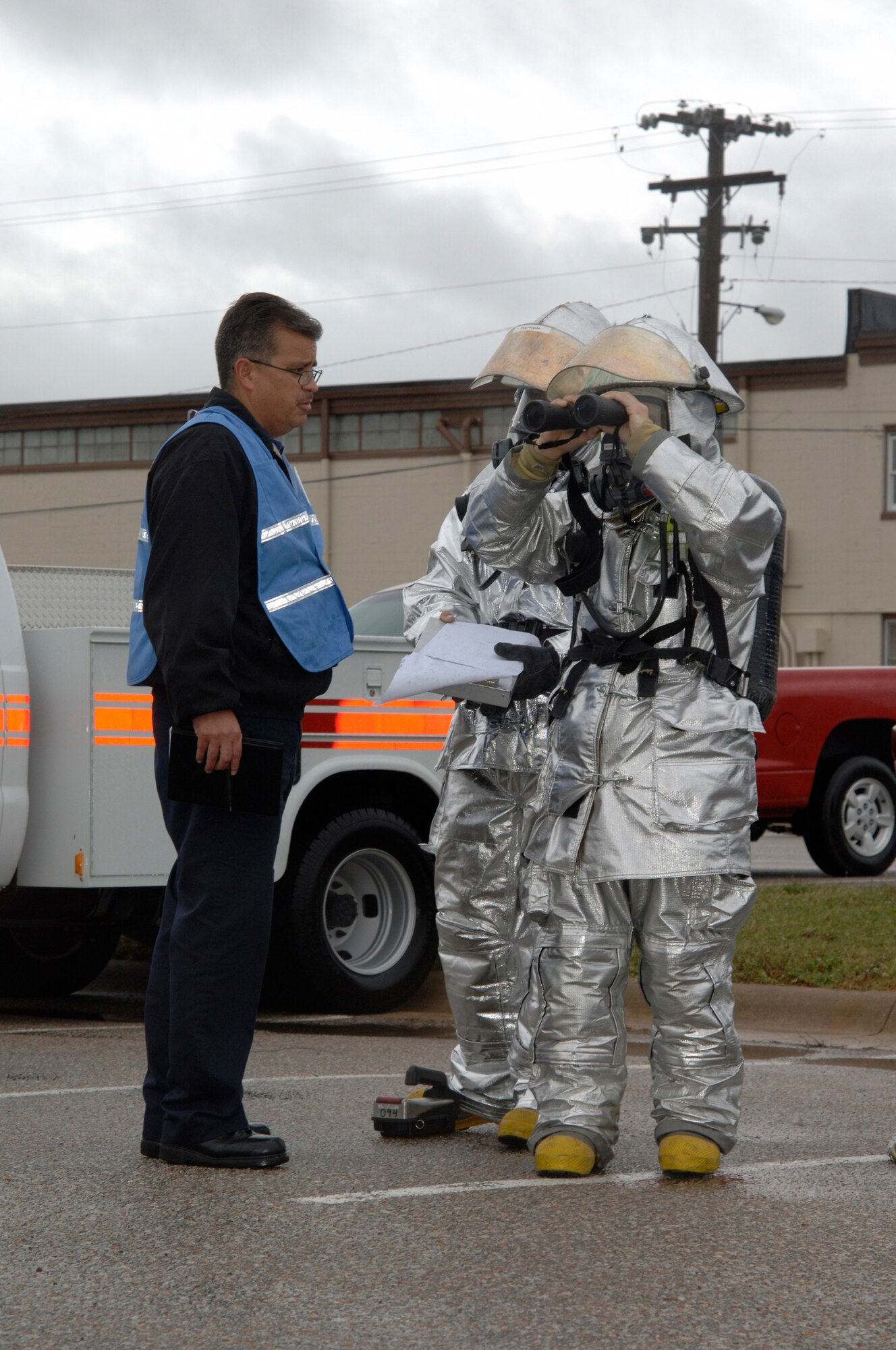 MCCONNELL AIR FORCE BASE, Kan. -- Members of the 22nd Civil Engineer Squadron fire department inspect a suspicious package from a distance outside of building 750, Oct. 15. The suspicious package was part of a major accident response exercise, testing the base’s procedures and response time if an emergency should occur. Firefighters remained at a safe distance while observing the package to ensure minimal contamination. (Photo by Senior Airman Laura Suttles)