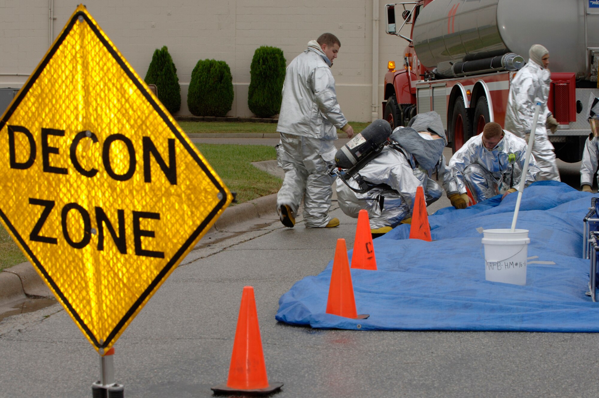 MCCONNELL AIR FORCE BASE, Kan. -- Members of McConnell’s fire department set-up a decontamination zone outside building 750 during a major accident response exercise, Oct. 15. The exercise involved a suspicious package outside building 750, which carried a simulated form of Anthrax. The bioenvironmental simulated a decontamination zone ensuring the water supply for the base was not contaminated with Anthrax. (Photo by Senior Airman Laura Suttles)