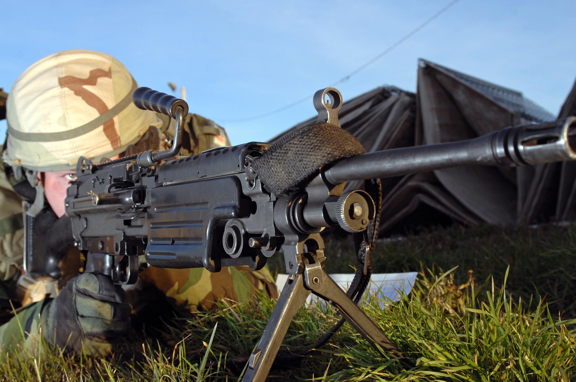Senior Airman Alexander Mendes, 28th Security Forces Squadron squad leader, provides perimeter security with an M-240 machine gun during an exercise here Oct. 22. The exercises are held before deployments to prepare security forces members for threats they may encounter. (U.S. Air Force photo by/Airman Corey Hook)