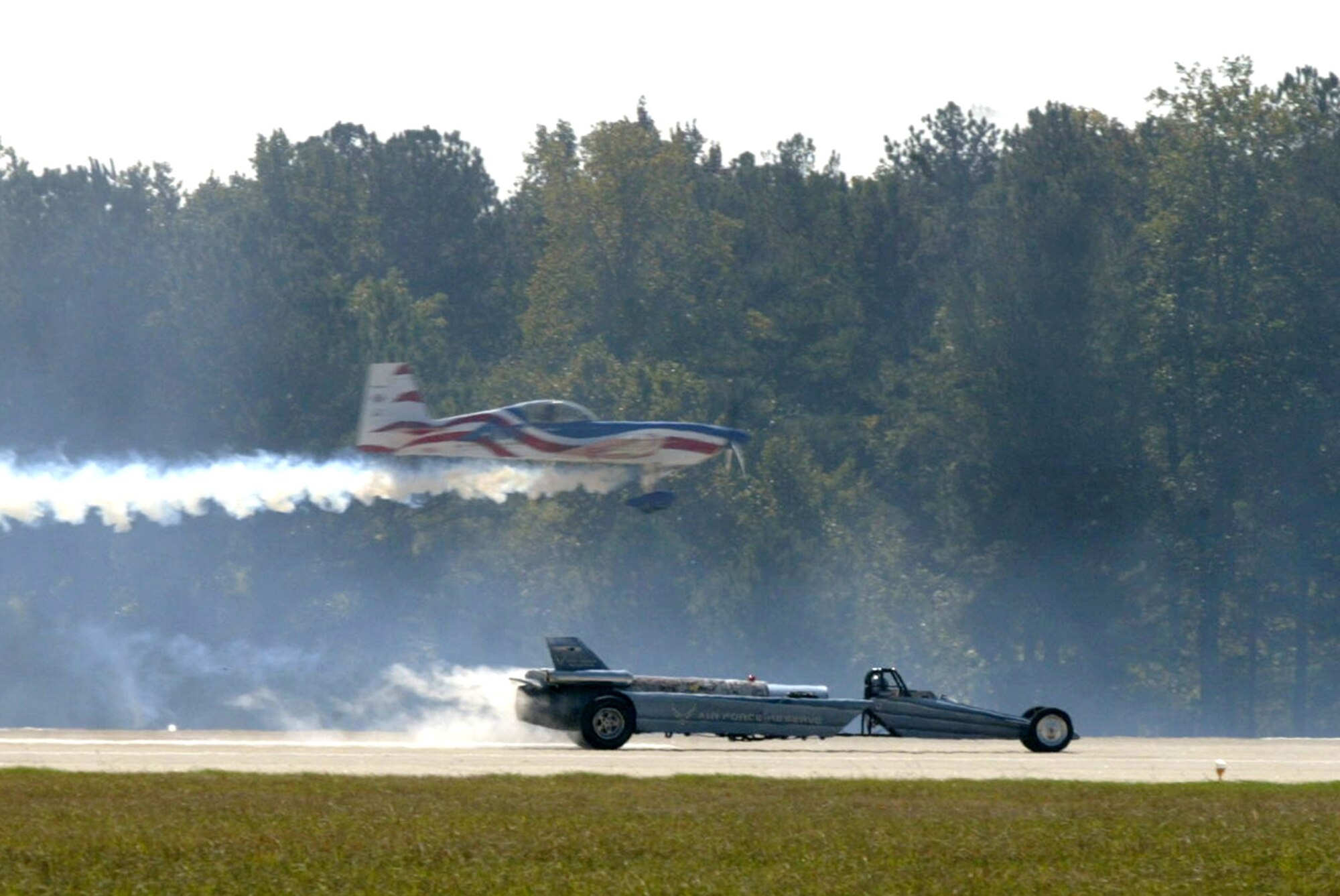 Air National Guard pilot John Klatt races his Staudacher aircraft against Bill Braack's Air Force Reserve Jet Car down the Dobbins runway Oct.18. The performers ended in a tie while the crowd won in excitement. Dobbins hosted the 2008 Wings Over Marietta Air Show Oct. 18-19, which featured an F-22 Raptor demo and the U.S. Air Force Thunderbirds. (Air Force photo/Don Peek) 