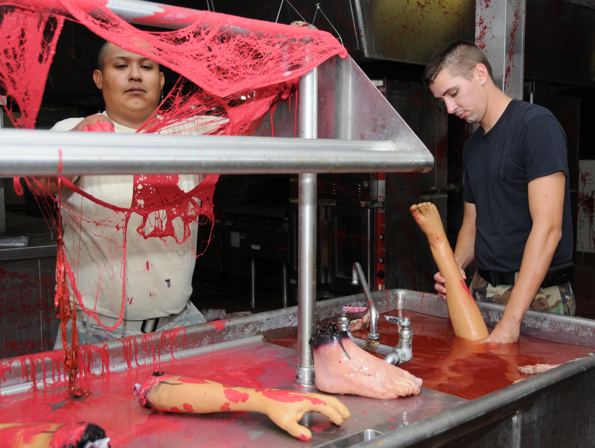 Airman 1st Class George Olivo, left, and Senior airman Christopher Freiman, 81st Civil Engineer Squadron, work on "The Asylum," the unit's haunted house.  (U.S. Air Force photo by Kemberly Groue)