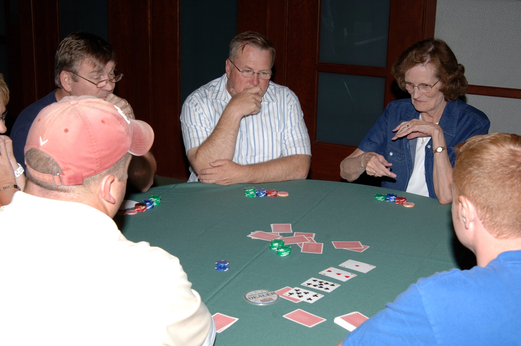 MCCONNELL AIR FORCE BASE, Kan. -- Team McConnell members play Texas Hold’em during a tournament at Club McConnell, Oct. 18. Tournaments are held at the club every Saturday at 6 and 8 p.m. until Nov. 15.  The winner of each session will earn a seat at the final tournament Nov. 22.  The tournament’s grand-prize winner will receive $500 in services bucks, which can be used to purchase tickets from Information Tickets and Travel, a massage from the fitness center, rent an inflatable, camper or boat from Outdoor Recreation.  (Photo by Staff Sgt. Ronald Lafosse)