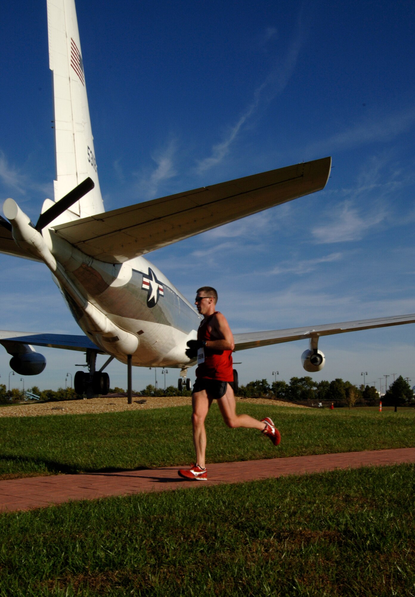 MCCONNELL AIR FORCE BASE, Kan. -- A local Wichita marathon runner glides by McConnell Air Force base’s Keeper of the Plains static display, Oct. 19. A portion of the Wichita marathon took runners through McConnell. (Photo by Senior Airman Laura Suttles)