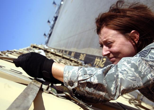Staff Sgt. Heather Kern secures a cargo shipment filled with force provider kits that will be airlifted to forward deployed locations in U.S. central command area of responsibility on Charleston AFB Oct. 22. The base has been shipping force provider kits to war fighters for more than a year. Sergeant Kern is assigned to the 437th Aerial Port Squadron. (U.S. Air Force photo/Airman 1st Class Timothy Taylor) 