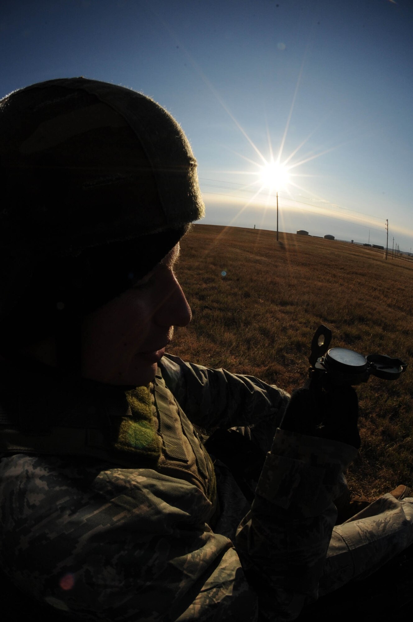 Senior Airman Shawn Mireles, 28th Security Forces Squadron leader, uses a compass to pinpoint specific points of latitude and longitude during an exercise here on Oct. 22. Airman Mireles analyzes data drawn together from surveillance and knowledge of geographical surroundings to complete the land navigation exercise. (U.S. Air Force photo/Airman 1st Class Adam Grant) 
