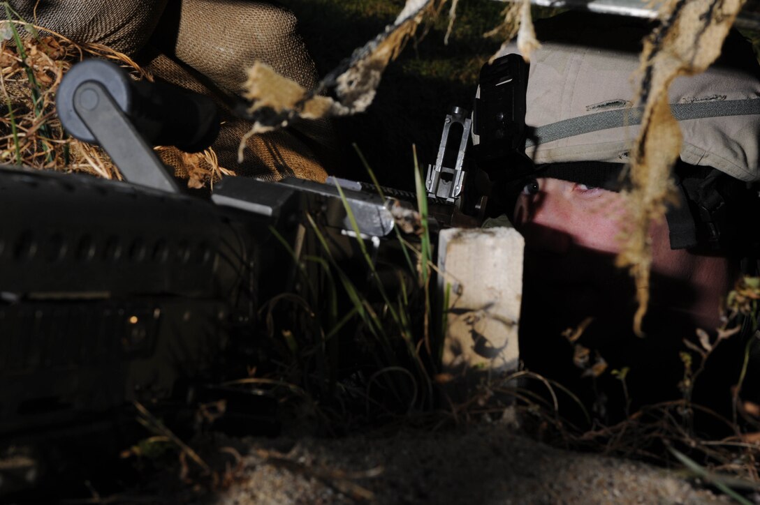 Airman 1st Class Chadwick Richardson, 28th Security Forces Squadron member, provides cover in a Defense Fighting Position during an exercise held here Oct. 22.  The Defense Fighting Position provides front line perimeter security with interlocking fields to protect resources from all directions. (U.S. Air Force photo/Airman 1st Class Adam Grant)  