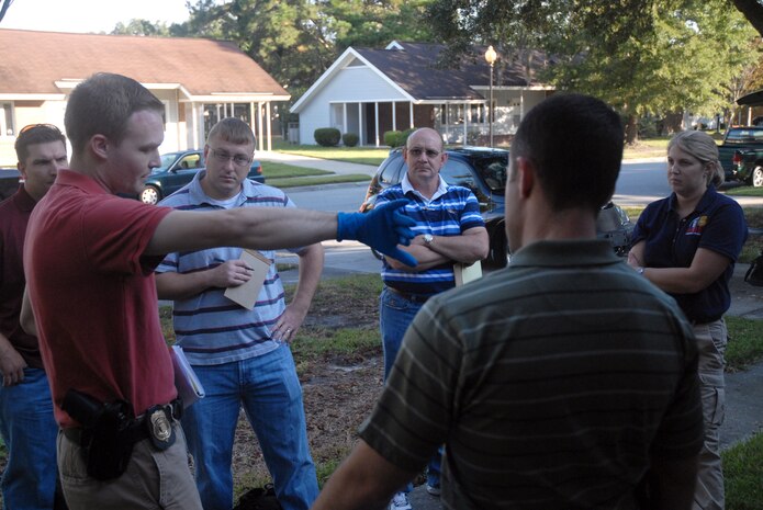 After a brief inspection of the exercise crime scene, Special Agent Matthew Tonay briefs investigation team members about details on the scene prior to completing a full investigation in base housing Oct. 17. The Air Force Office of Special Investigations Detachment 310 put together an exercise to test their investigatory preparedness and to work with their counterparts with the 437th Security Forces Squadron and the 437th Airlift Wing Law Center. Agent Tonay is assigned to AFOSI Det. 310. (U.S. Air Force photo/Staff Sgt. Sam Hymas)