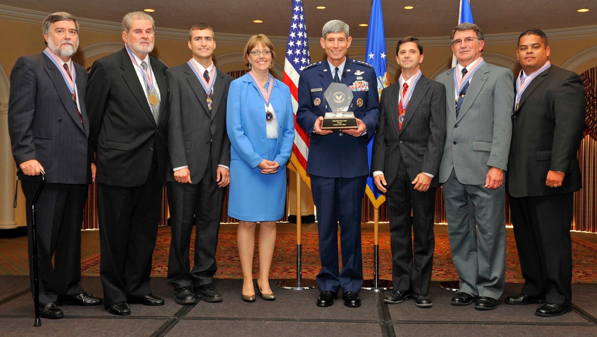 General Norton Schwartz, U.S. Air Force chief of staff, awards the 2008 Chief of Staff Team Excellence Award to the Nellis Solar Power Team at the Omnishore Hotel, Washington DC, Sep. 16. Pictured from left to right are James Snook, Air Force Civil Engineer Support Agency, Gene Rogers, Nellis deputy base civil engineer, Jeffrey Blazi, Nellis AFB utility manager, Lt. Col. Karen White, AFCESA, Gen. Schwartz, Steven Dumont, Air Combat Command, Tomas White, ACC, David Robledo, Nellis project contracting officer.  Members not pictured are Lynn Haarklau, National Environmental Policy Act  manager, and Michelle Price, Nellis energy manager. (courtesy photo)
