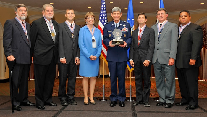 General Norton Schwartz, U.S. Air Force chief of staff, awards the 2008 Chief of Staff Team Excellence Award to the Nellis Solar Power Team at the Omnishore Hotel, Washington DC, Sep. 16. Pictured from left to right are James Snook, Air Force Civil Engineer Support Agency, Gene Rogers, Nellis deputy base civil engineer, Jeffrey Blazi, Nellis AFB utility manager, Lt. Col. Karen White, AFCESA, Gen. Schwartz, Steven Dumont, Air Combat Command, Tomas White, ACC, David Robledo, Nellis project contracting officer.  Members not pictured are Lynn Haarklau, National Environmental Policy Act  manager, and Michelle Price, Nellis energy manager. (courtesy photo)