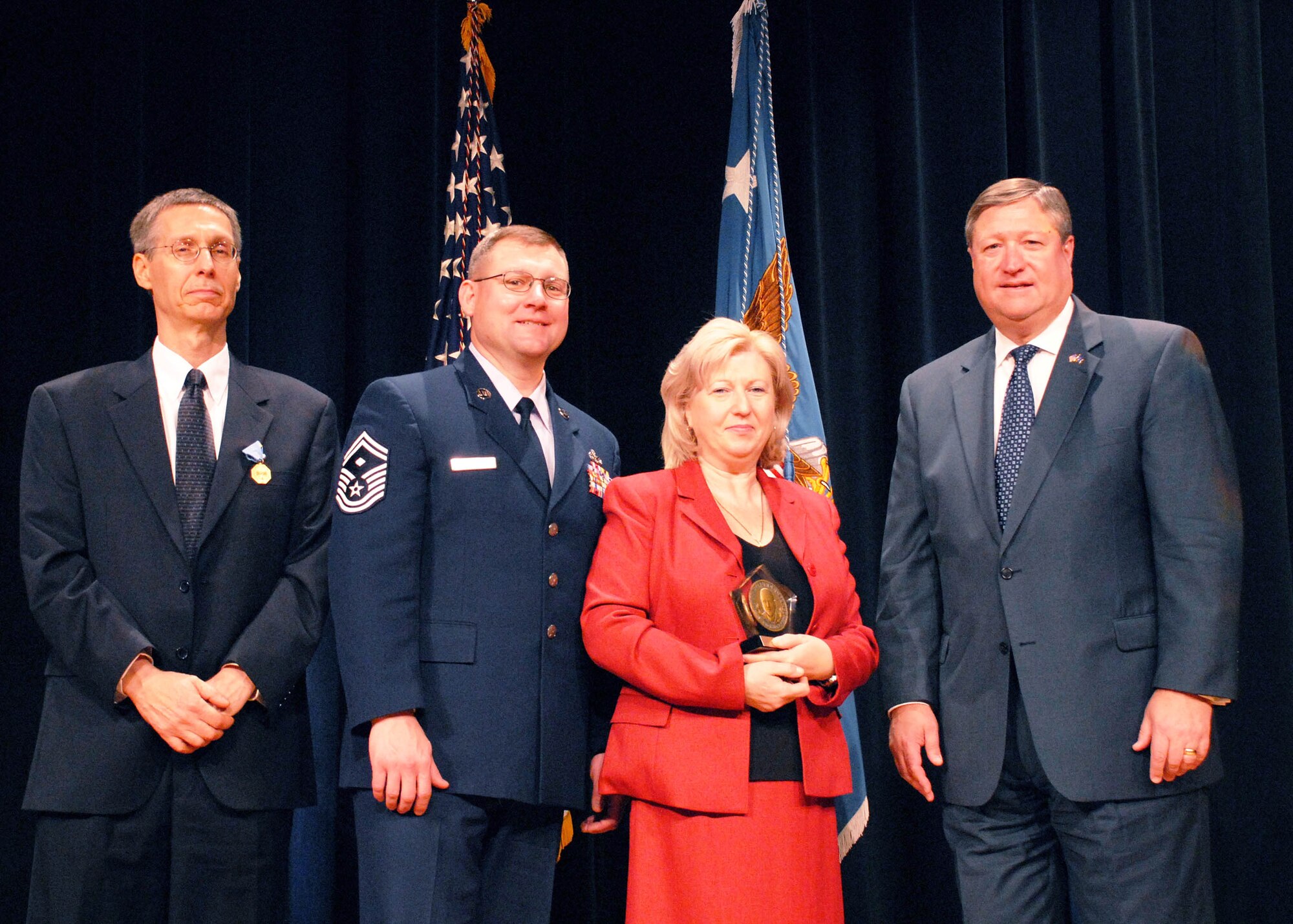 Secretary of the Air Force Michael B. Donley (right) joins Edmund G. Zelnio and Umit Spencer, and her husband Senior Master Sgt. David L. Spencer following an awards ceremony Oct. 21 in the Pentagon where Mr. Zelnio and Ms. Spencer were honored.  Mr. Zelnio received the Department of Defense Medal for Distinguished Civilian Service for his work as senior electrical engineer at the Air Force Research Laboratory at Wright-Patterson Air Force Base, Ohio. Ms. Spencer received the DOD David O. Cooke Excellence in Public Administration Medallion for her work as housing maintenance contract monitor for the 354th Civil Engineer Squadron at Eielson Air Force Base, Alaska.  Secretary of Defense Dr. Robert M. Gates presented the awards.  (U.S. Air Force photo/Master Sgt. Russell P. Petcoff) 