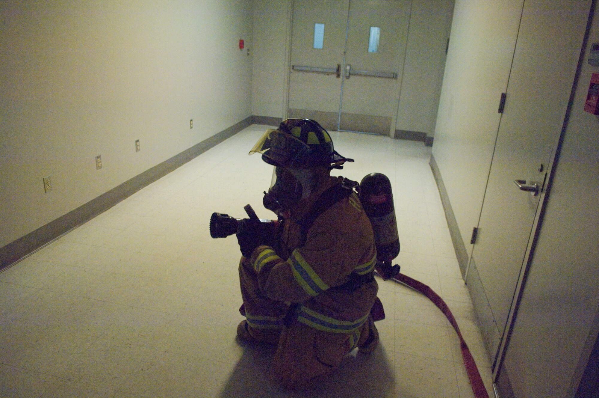 HANSCOM AIR FORCE BASE, Mass. – A fireman waits for word to move in on a simulated fire in building 1102F, during an emergency management exercise on Oct. 20. Hanscom will wrap up this week’s Base Readiness Exercise with a Unit Compliance Inspection, Targeted Readiness Inspection pep rally in the Tennis Bubble today at 1:30 p.m.  (U.S. Air Force photo by Rick Berry)