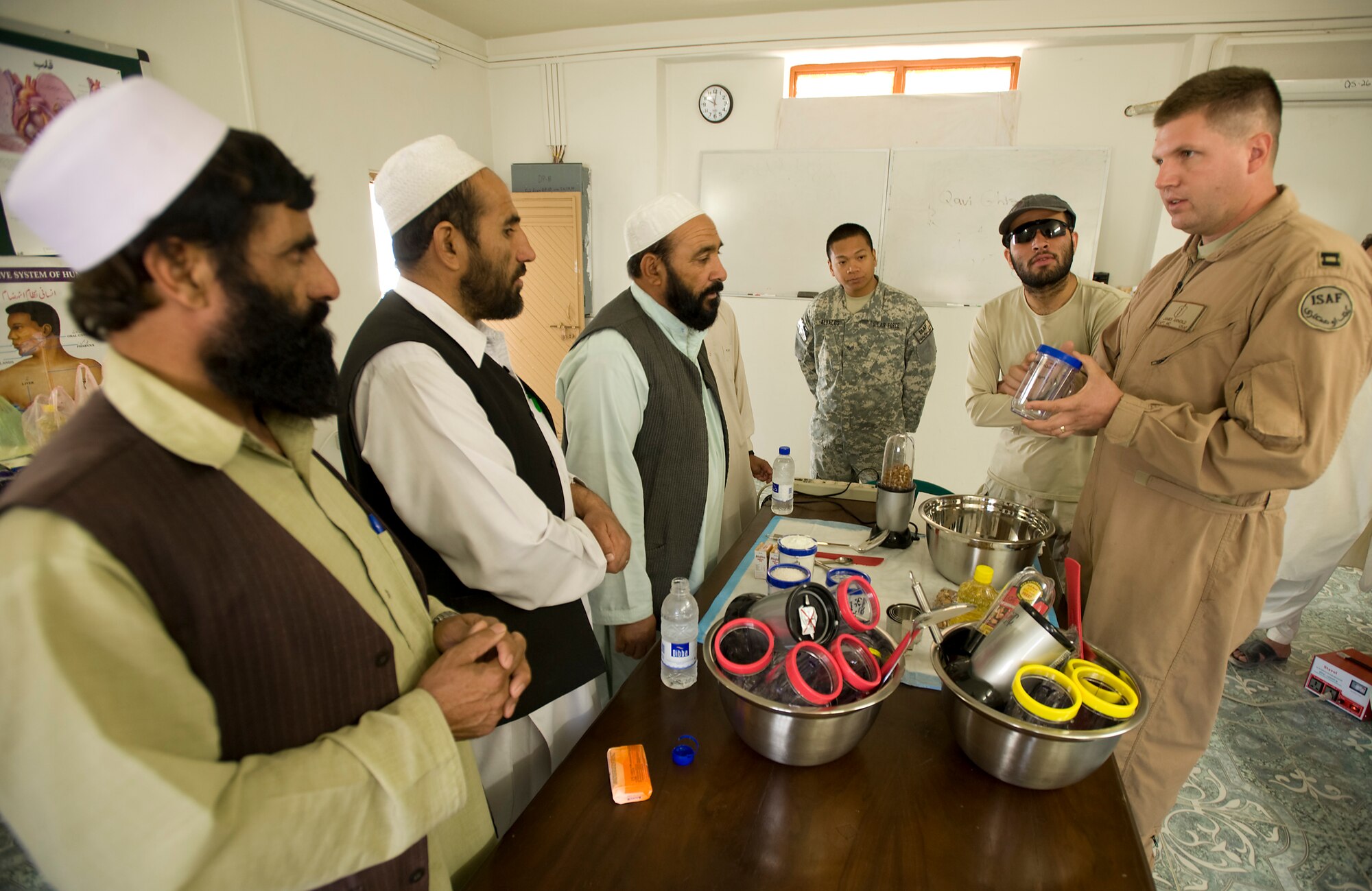 QALAT. Afghanistan -- Capt. (Dr.) James Arnold shows medical professionals from the Zaubl province how to make "strong food." "Strong food" is a vitamin enriched high calories food supplement used to combat malnutrition. The Zabul Provincial Reconstruction Team medical staff is working with local heath officials to combat the main causes of the extremely high infant mortality in the area such as unsanitary water supplies and malnutrition. Dr. Arnold is deployed from Anderson Air Force Base, Guam. (U.S. Air Force photo/Master Sgt. Keith Brown)