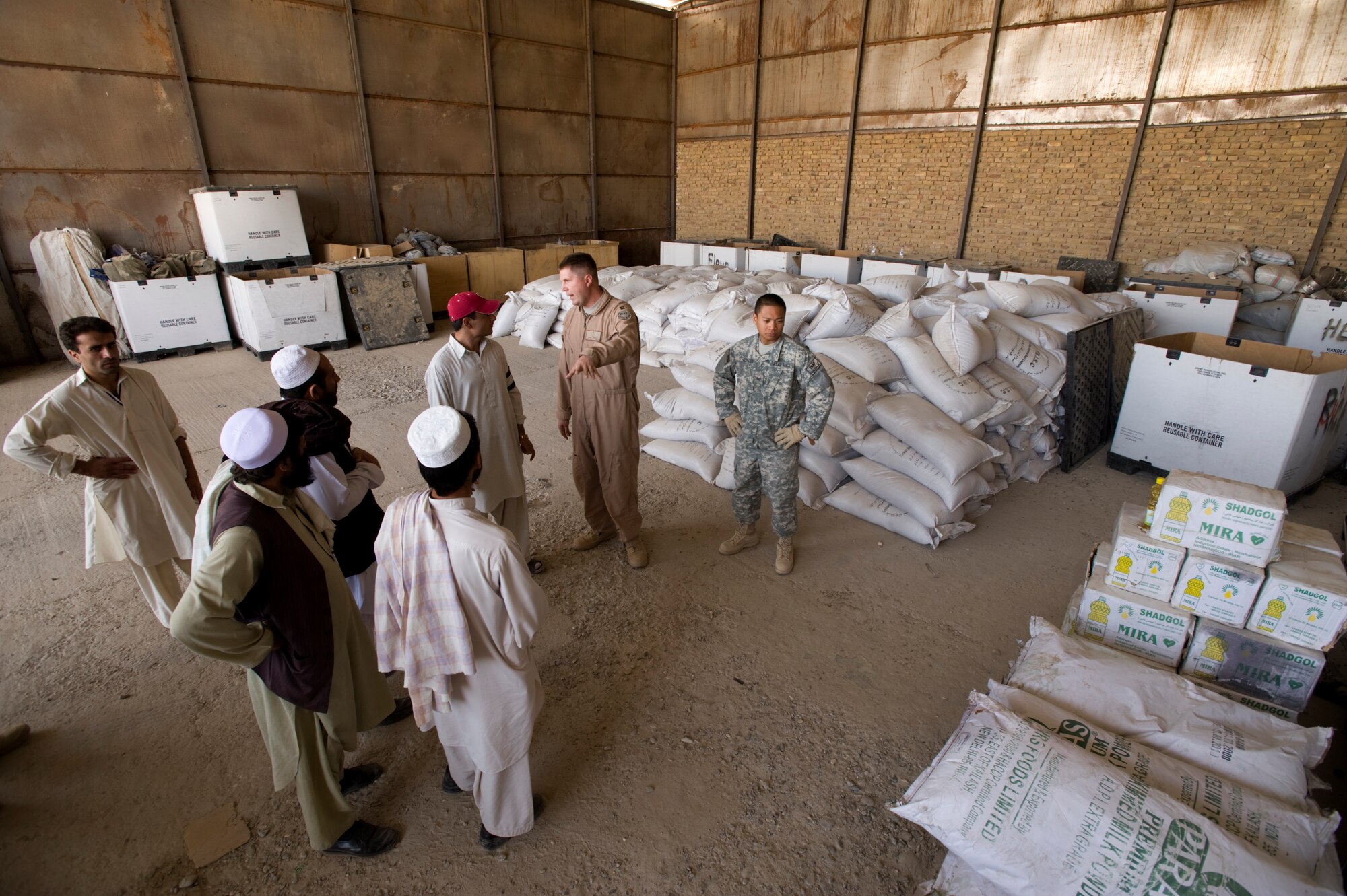 QALAT. Afghanistan -- Members of the Zabul Provincial Reconstruction Team medical staff discuss how to divide up “strong food” ingredients with local medical professionals from the Zabul province hospitals. "Strong food" is a vitamin enriched high calories food supplement to combat malnutrition. The PRT is working with local heath officials to combat the main causes of the extremely high infant mortality in the area such as unsanitary water supplies and malnutrition. (U.S. Air Force photo/Master Sgt. Keith Brown)