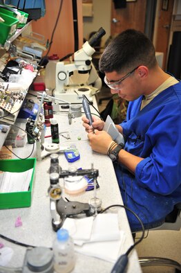 Senior Amn Richard Sandoval, 355th Dental Squadron dental laboratory technician, fabricates a parcelain crown for a patient here, October 17. (U.S. Air Force photo/Senior Airman Noah R. Johnson) 