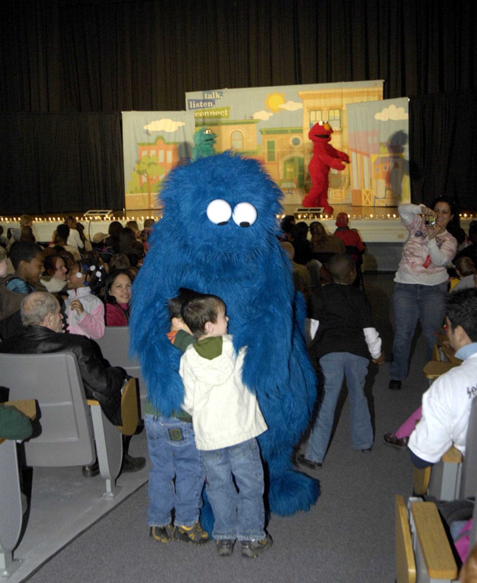 Cookie Monster hugs children in the crowd during the Sesame Street Military Experience held at the Timmermann Center Oct. 18. Prior to the show, a picnic was held at John Mann Park at Fort Dix for servicemembers and their families. Children were able to interact with their favorite Sesame Street characters. (U.S. Army photo/Jennifer McCarthy)