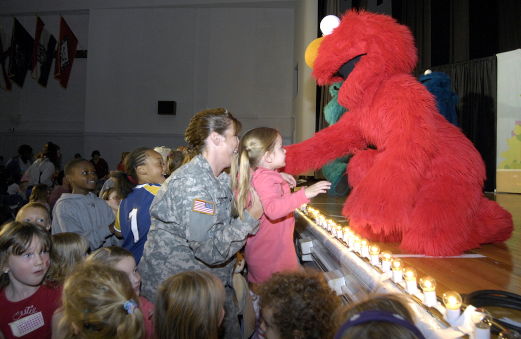 Elmo reaches out to the crowd during the Sesame Street Experience for Military Families held Oct. 18 at the Fort Dix Timmermann Center. The Sesame Street Experience for Military Families is a free show produced by Sesame Workshop, in conjunction with the United Services Organization and Vincent E. Egan Corporation. It is part of Sesame Workshop’s Talk, Listen, Connect initiative. (U.S. Army photo/Jennifer McCarthy)