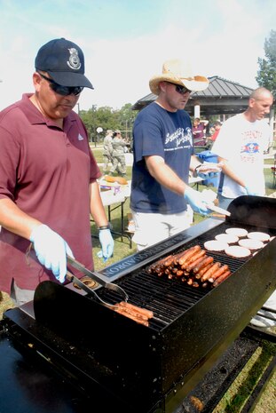 From left to right, Chief Master Sgt. Larry Savidge, Master Glenn Phillips, and Master Ken Carter, cook hotdogs and hamburgers during the Oktoberfest held on Charleston AFB Oct. 17.  The Charleston AFB Top 3 provided food, drinks and entertainment for junior ?enlisted Airmen during the annual event. The three senior NCOs are all with the 437 SFS.  (U.S. Air Force photo/Staff Sgt. Jennifer Arredondo)