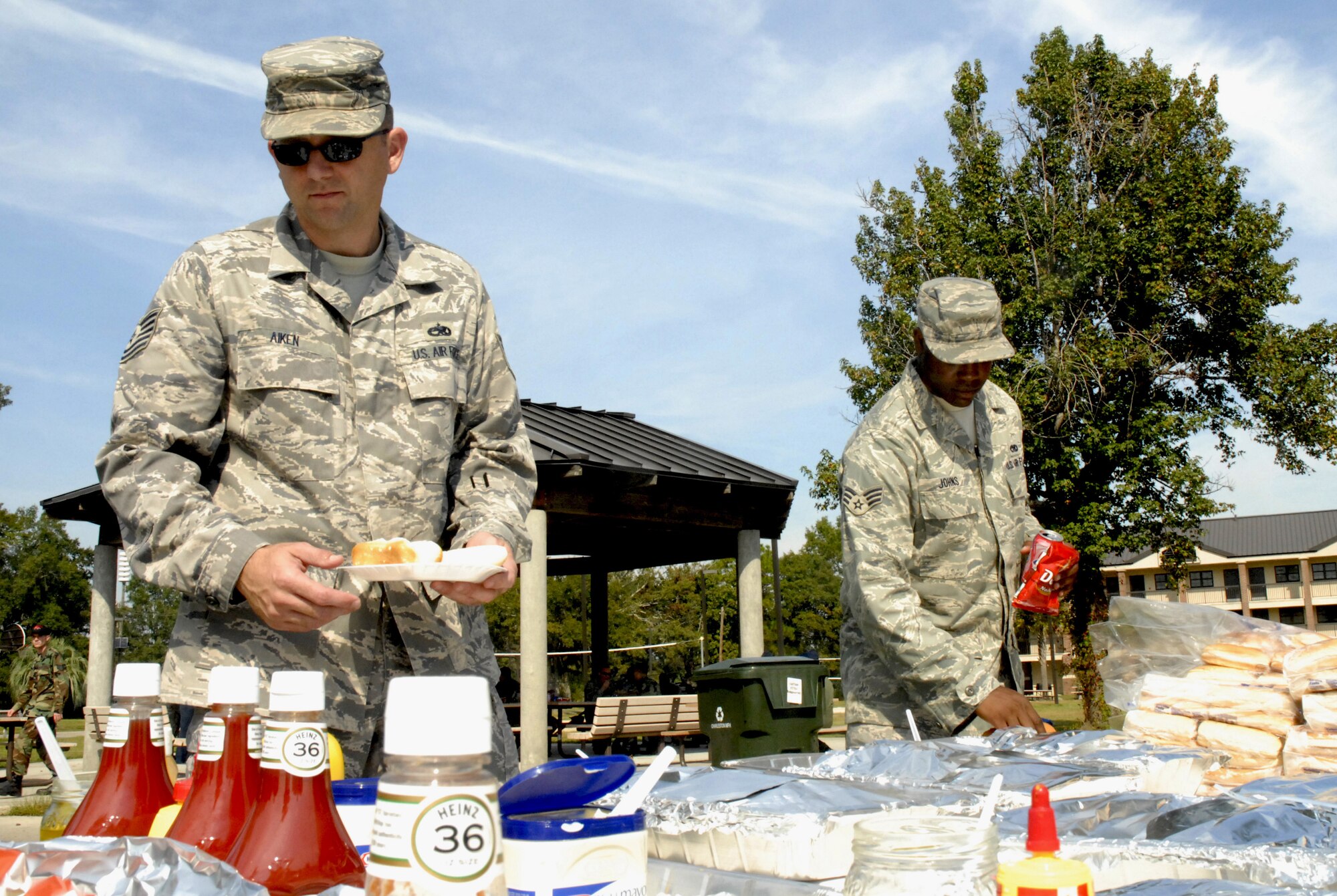 Tech. Sgt. Ivan Aiken, left, and Senior Airman DeMarcus Johns help themselves to hamburgers, hotdogs and bratwurst during the Oktoberfest held on base Oct. 17. The Charleston AFB Top 3 provided food, drinks and entertainment for junior?enlisted Airmen during the annual event.  Sergeant Aiken is with the 373rd Training Squadron, Detachment 5 and Airman Johns is with the 437th Maintenance Squadron. (U.S. Air Force photo/Staff Sgt. Jennifer Arredondo)