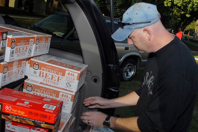 Master Sgt. Jeffrey Wagner unloads hamburgers and hot dogs from a vehicle in preparation for Oktoberfest on Charleston AFB Oct. 17. The Charleston AFB Top 3 provided food, drinks and entertainment for junior-enlisted Airmen during the annual event. Sergeant Wagner is  with the 437th Security Forces Squadron. (U.S. Air Force photo/Master Sgt. Paul Kilgallon)