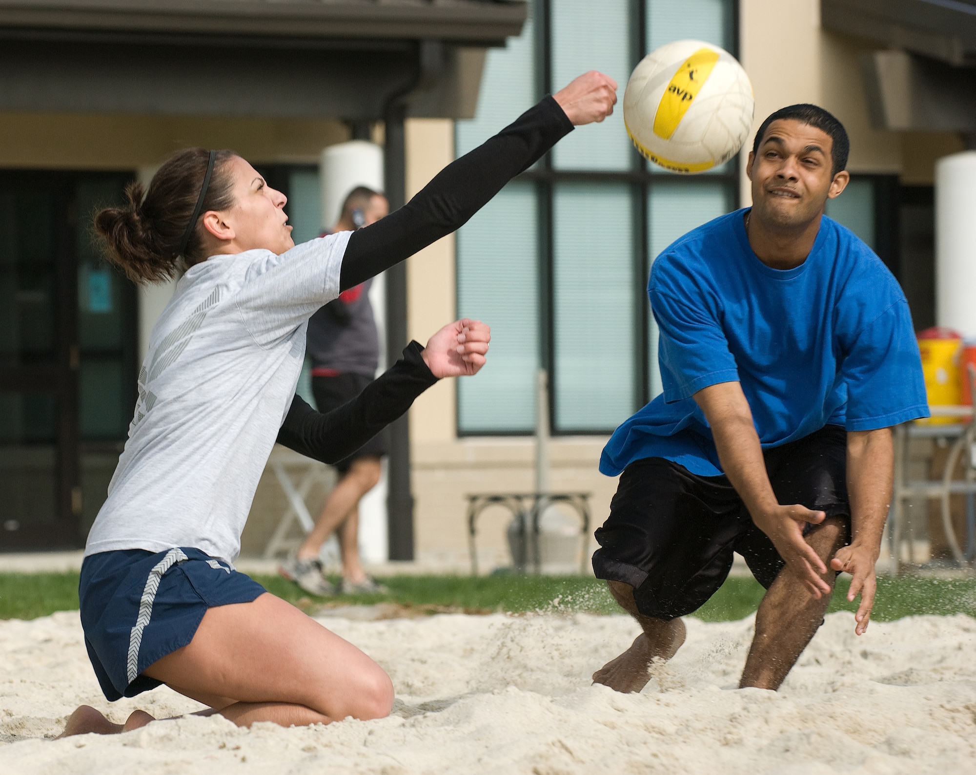 Airman 1st Class Heather Conaway (left) and Senior Airman Luis Walker (right), 436th Mission Support Squadron, return a serve while playing beach volleyball during Wing Sports Day Oct. 17.   (U.S. Air Force photo/Jason Minto)
