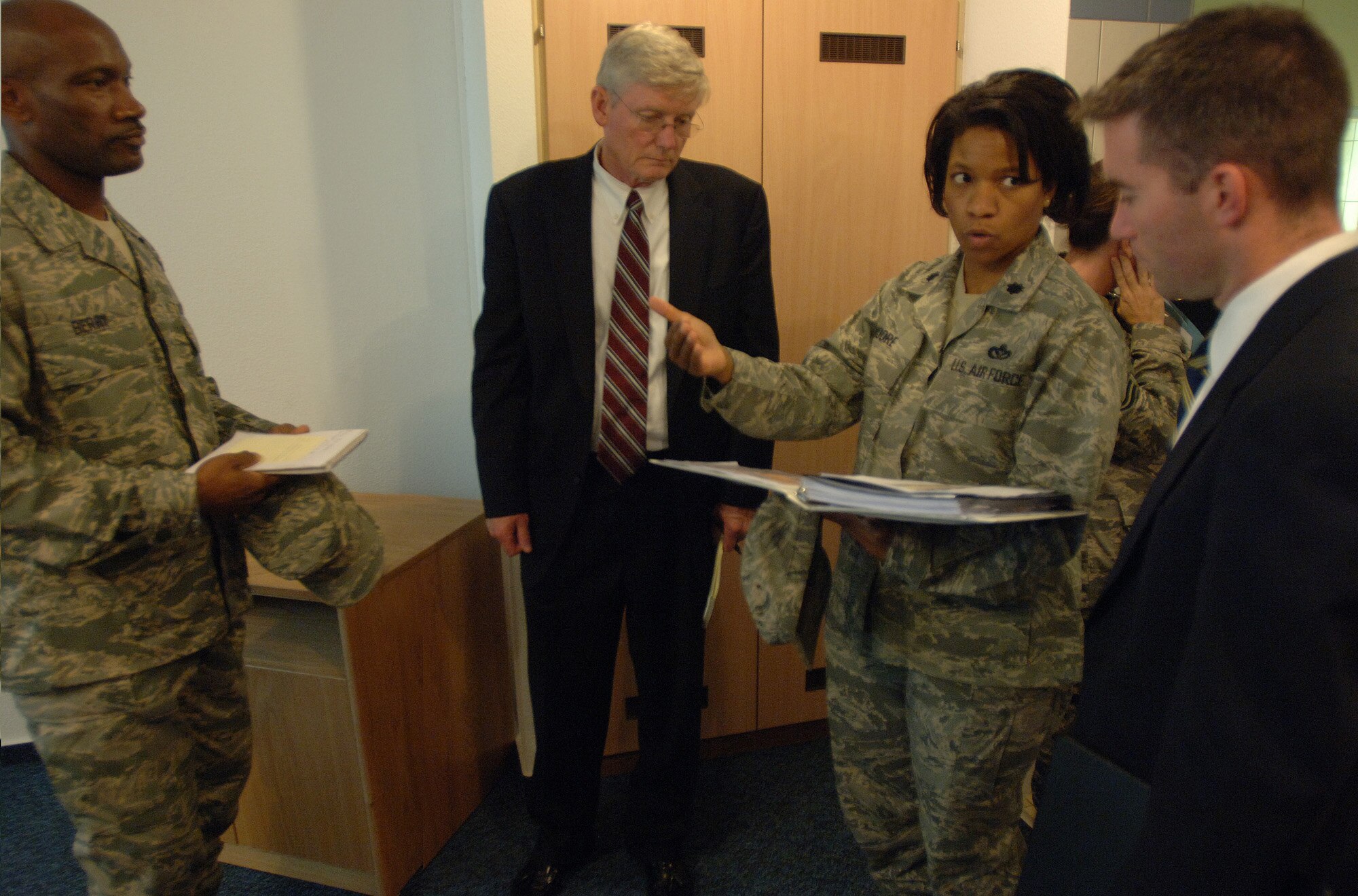 Lt. Col. Bobbie Moore, 435th Civil Engineering Squadron commander, describes how maintenance repairs impact Airmen living in unaccompanied dorms with House Appropriations Committee staff delegates, Keith Baker (center) and Adam Johnson. The discussion was part of a DOD-wide investigation that canvassed nearly 60 installations. (DOD photo/ Master Sgt. Scott Wagers)