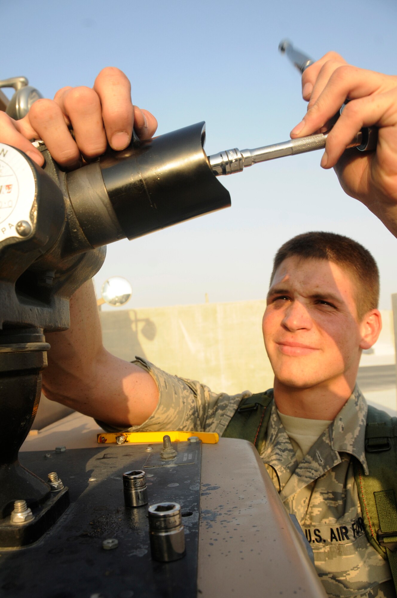 Senior Airman Travis Lyman, crash truck mechanic assigned to the 379th Expeditionary Logistics Readiness Squadron, uses a ratchet to tighten a spray washer on the bumper turret of a P-19 crash truck Oct. 20, 2008, at an undisclosed air base in Southwest Asia.  Airman Lyman, a native of Klamath Falls, Ore., is deployed from Kingsley Field Air National Guard Base, Ore., in support of Operations Iraqi and Enduring Freedom and Joint Task Force-Horn of Africa. (U.S. Air Force photo by Staff Sgt. Darnell T. Cannady/Released)