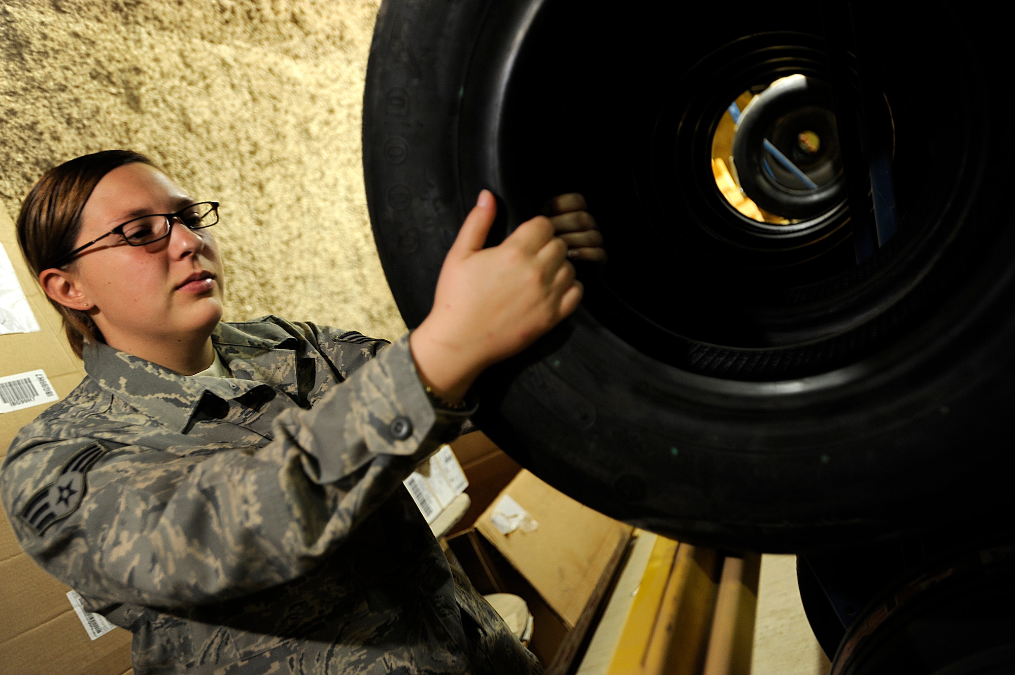 Senior Airman Heather Libiszewski retrieves an F-16 Fighting Falcon tire Oct. 10 at Joint Base Balad, Iraq. She recently helped put out a fire in the Aircraft Supply Store here, saving millions of dollars in Air Force assets. Libiszewski, a supply technician assigned to the 332nd Expeditionary Logistics Readiness Squadron, is deployed from Westover Air Reserve Base, Mass., and her hometown is Warren, Mass. (U.S. Air Force photo/Airman 1st Class Jason Epley)