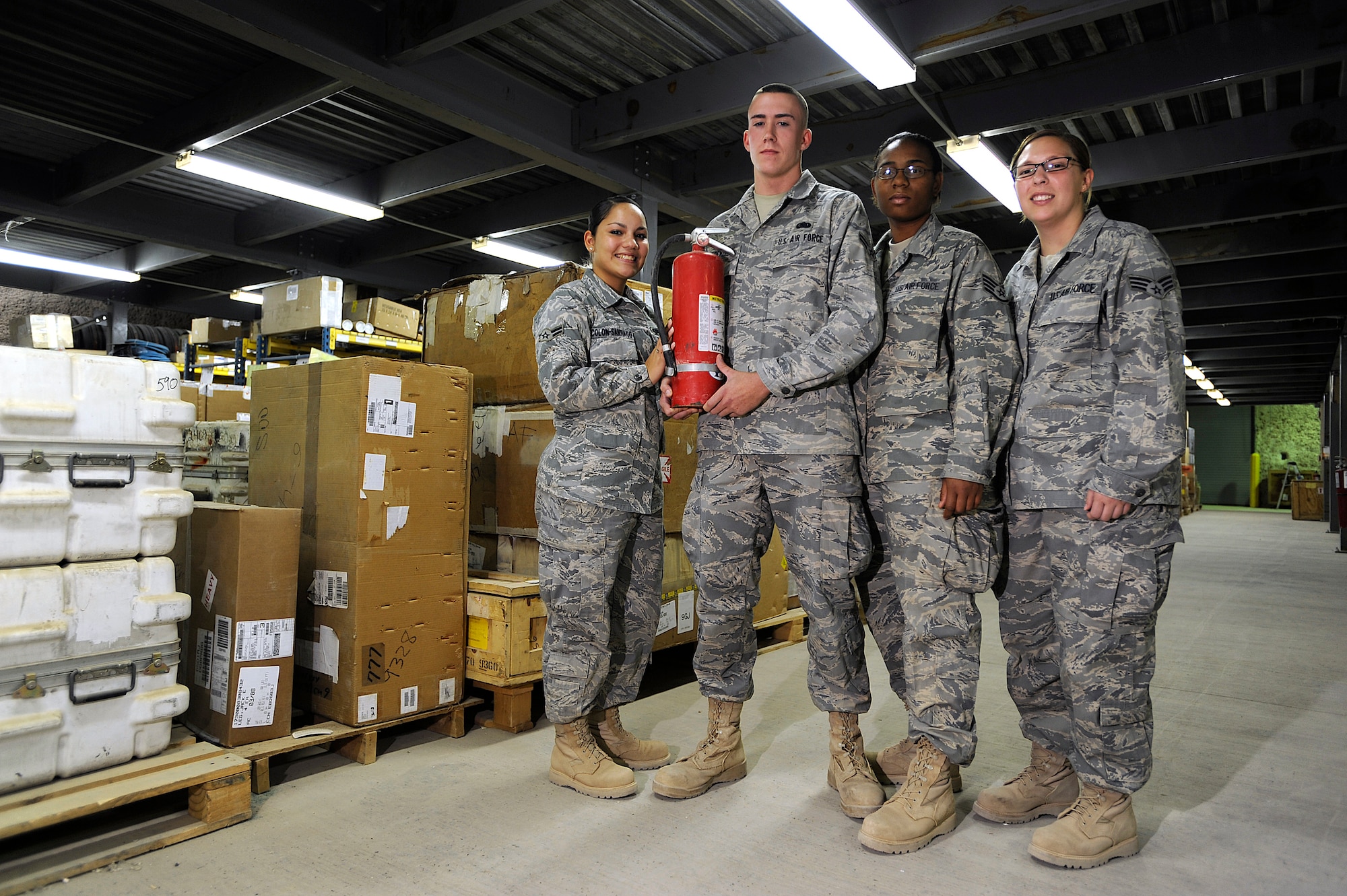Airman 1st Class Mayra Colon-Santiago, Airman 1st Class Martin Renzi, Staff Sgt. Akeilee Murchison and Senior Airman Heather Libiszewski pose with the fire extinguisher they used to put out a fire in the Joint Base Balad, Iraq, Aircraft Supply Store Sept. 22. Their quick response in extinguishing the fire saved millions of dollars in Air Force assets. All Airmen are supply technicians assigned to the 332nd Expeditionary Logistics Readiness Squadron. Colon-Santiago is deployed from McGuire Air Force Base, N.J., and her hometown is Harvest, Ala. Renzi is deployed from McGuire AFB and his hometown is Gloucester, N.J. Murchison is deployed from Westover Air Reserve Base, Mass., and her hometown is Springfield, Mass. Libiszewski is deployed from Westover ARB and her hometown is Warren, Mass. (U.S. Air Force photo/Airman 1st Class Jason Epley)