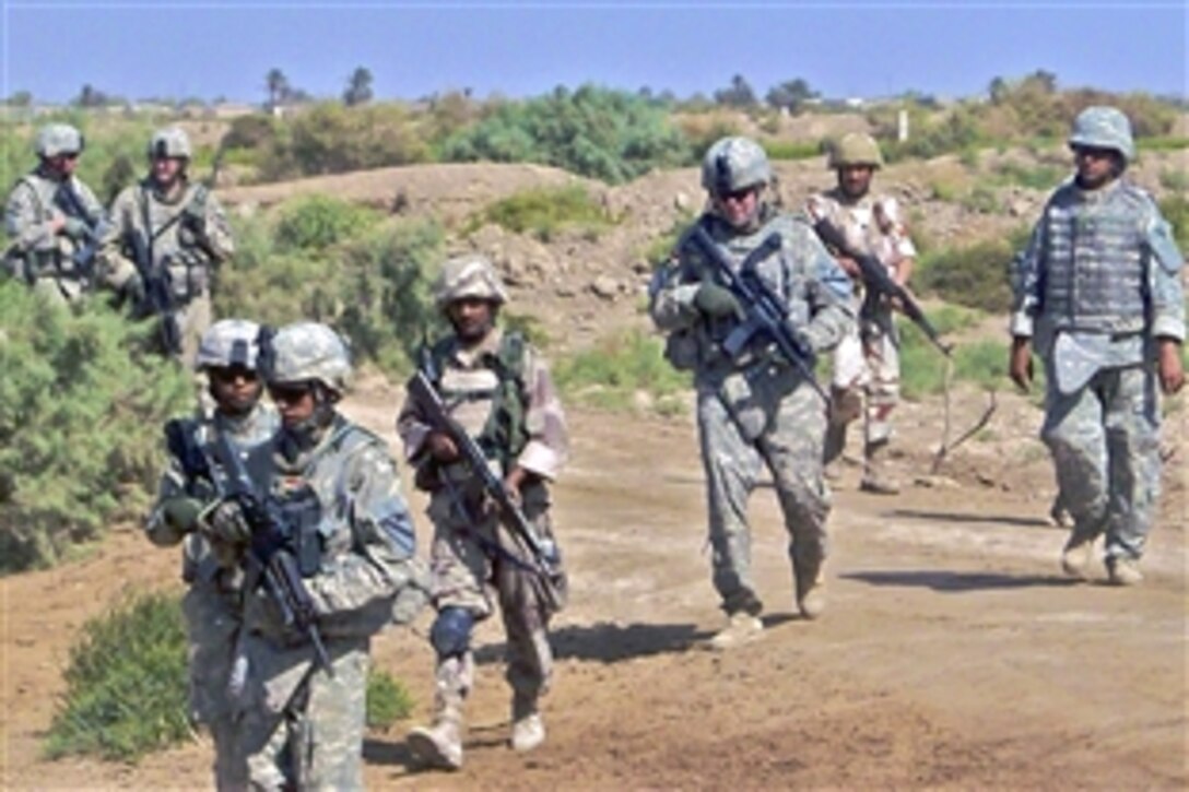 U.S. and Iraqi soldiers move out on foot during an air assault as part of Operation Stockton II near Amarah, Iraq, Oct. 18, 2008. The soldiers are assigned to the 1st Cavalry Division's 5th Battalion, 82nd Field Artillery Regiment, 4th Brigade Combat Team.
