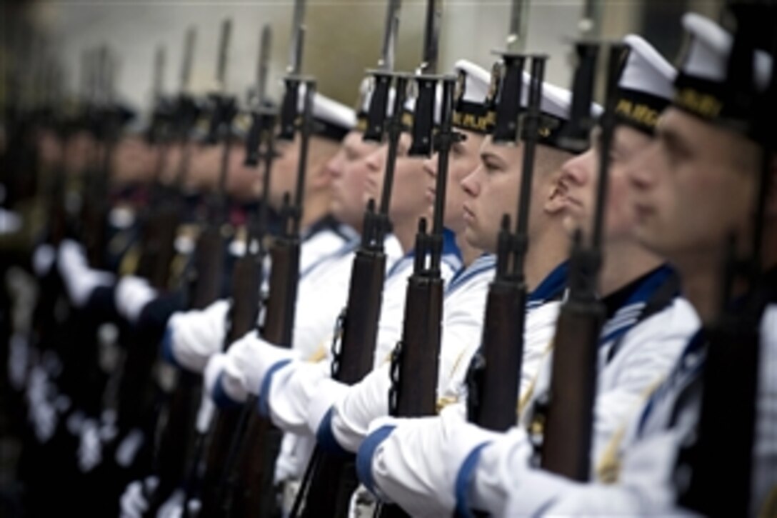 Lithuanian honor guard sailors salute U.S. Navy Adm. Mike Mullen, chairman of the Joint Chiefs of Staff, at a ceremony welcoming Mullen to Vilnius, Lithuania, Oct. 22, 2008. Mullen is on a three-day, four-country trip to meet defense counterparts.