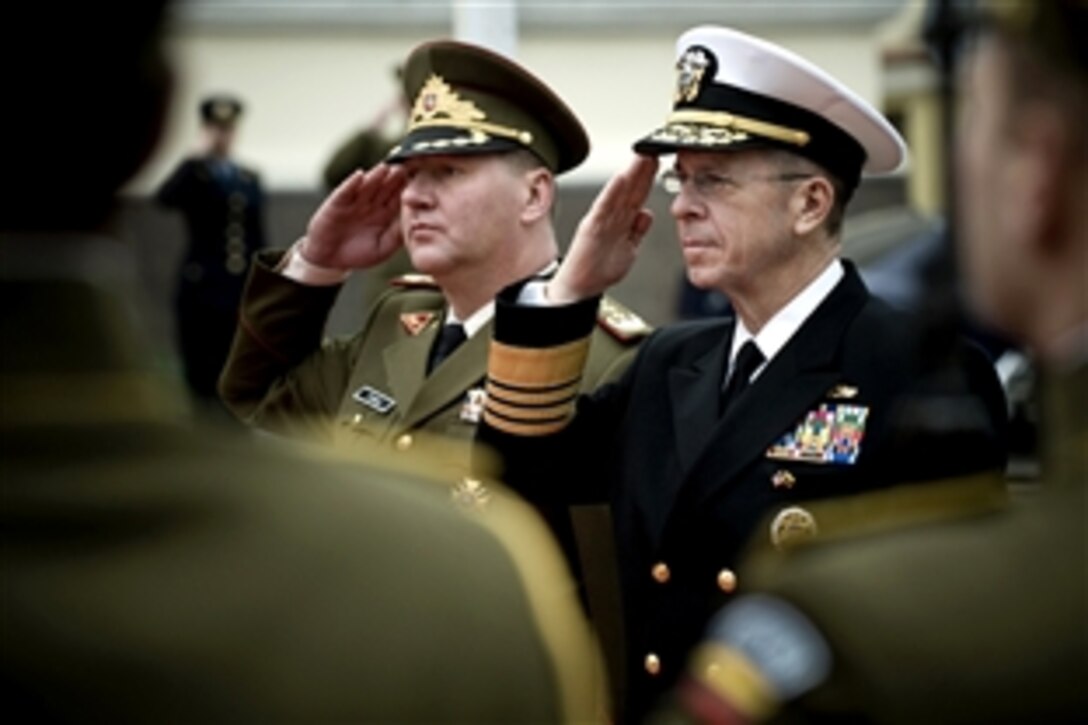 U.S. Navy Adm. Mike Mullen, chairman of the Joint Chiefs of Staff, and Lt. Gen. Valdas Tutkus, chief of defense, Republic of Lithuania, salute during the playing of national anthems for their countries at a ceremony welcoming Mullen to Vilnius, Lithuania, Oct. 22, 2008. Mullen is on a three-day, four-country trip to meet defense counterparts.