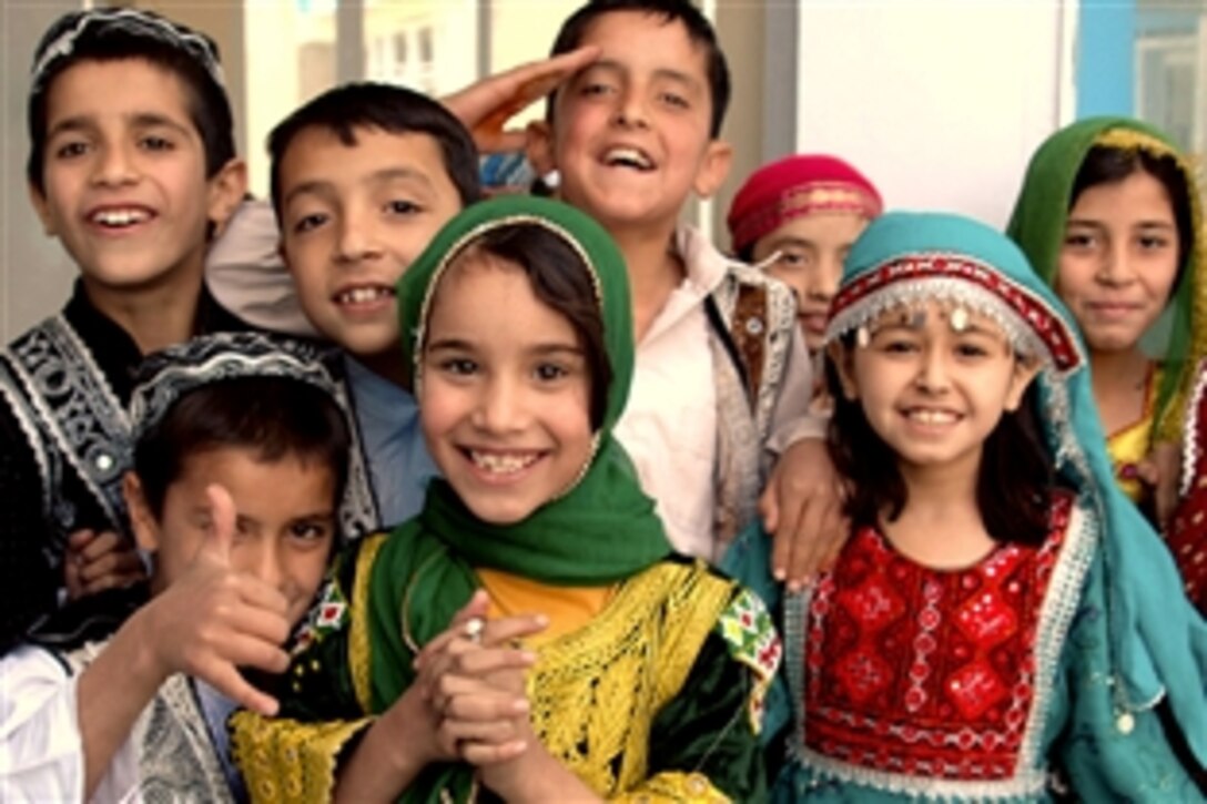 Afghan children show their delight at the opening of a new wing at the Tajwar Sultana Girls School in Kabul, Afghanistan, during a celebration beginning Oct. 18, 2008. Combined Joint Task Force Phoenix, based on Camp Phoenix, Afghanistan, has been investing U.S. funds in Afghan school projects to support the Afghan government and its people. 